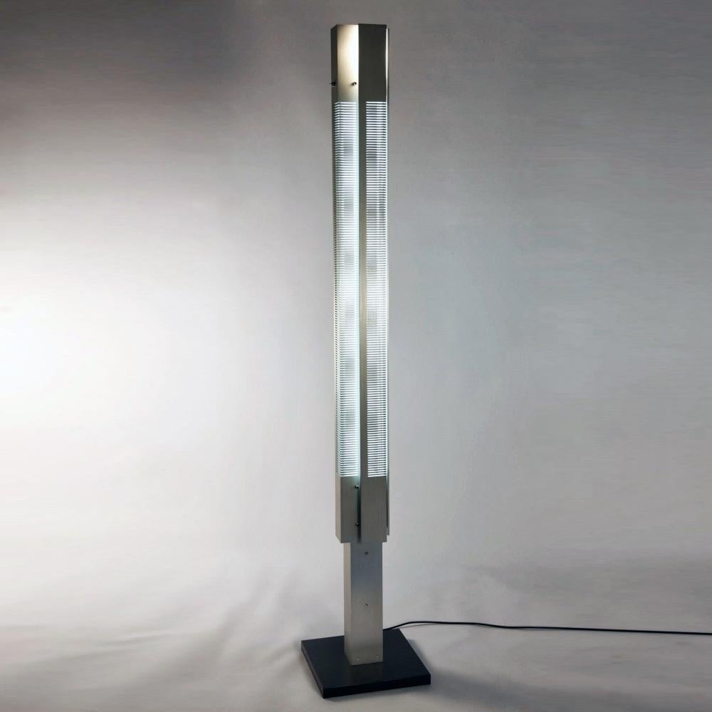 Steel pedestals featuring a combination of incandescent and fluorescent lighting. Each glows through rhythmical cuts in solid panes.

The upper part is composed of four elements taken from a thin, shaped sheet of composite metal.

COLOR