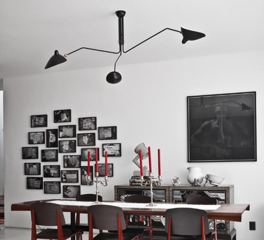 Serge Mouille 'Plafonnier 3 Bras Pivotants' ceiling lamp in black.

Originally designed in 1958, this iconic chandelier is still made by Edition Serge Mouille in France using many of the same small-scale manufacturing techniques and scrupulous