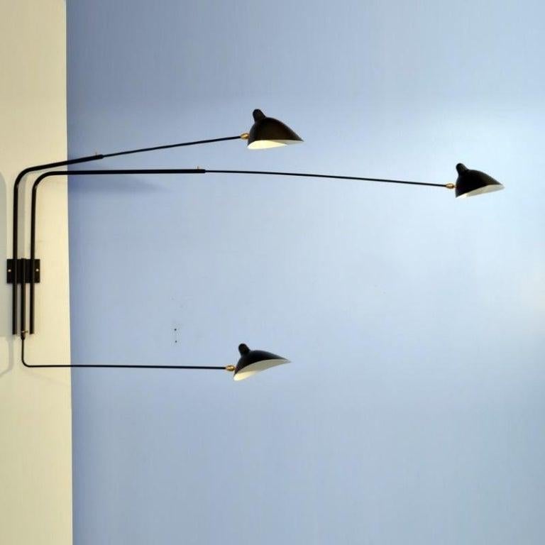 With arms measuring 52, 58 and 91 inches, this sconce can project light into a room at varying angles due to the independent rotation of each arm and each shade. Switches located on mounting plate. 

Made of a steel body and brass swivel with