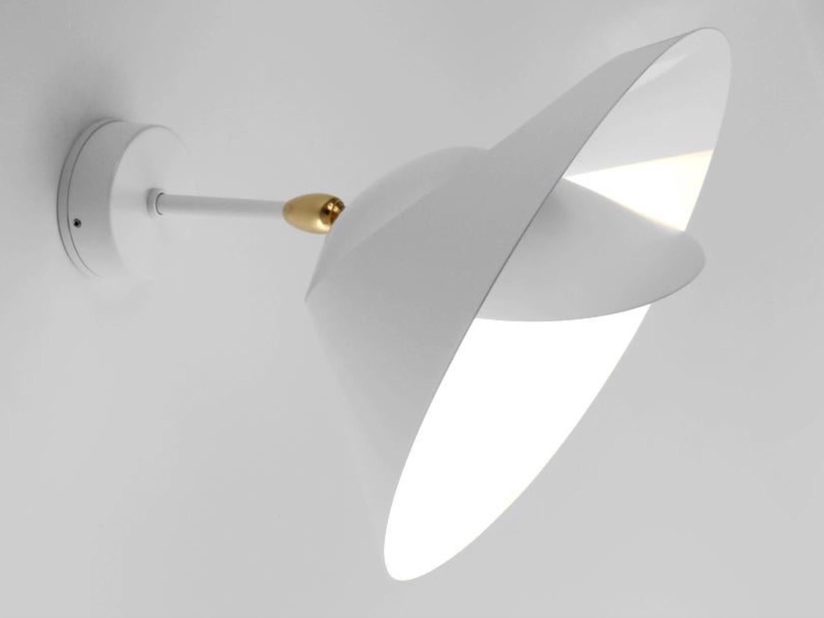 Wall lamp 'Saturne' in white version. Listed as 220-240 Voltage but can be used with right bulb in US, Canada hardwired or with plug as plug in. 

Originally designed in 1957, this iconic lamp is still made by Edition Serge Mouille in France using