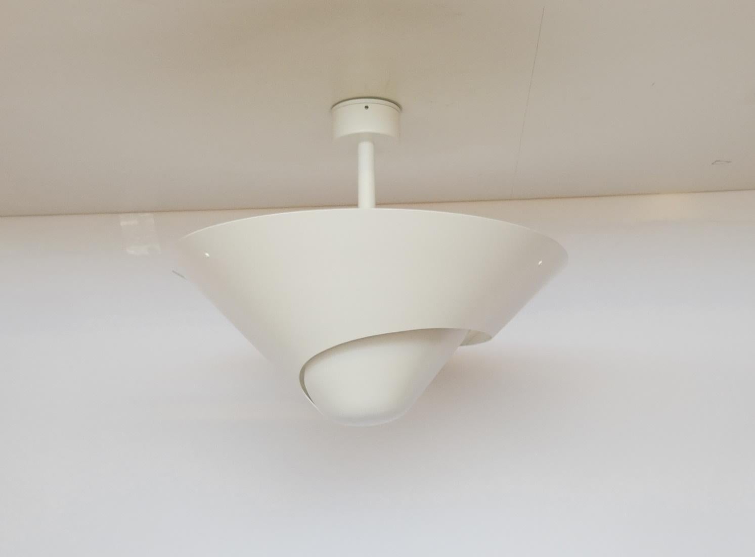 A snail shell provides the inspiration for this lamp with its swirling cut out in the circular shade. Light projects downward through the opening while the shade causes light to reflect from the ceiling.

Custom drop lengths upon approval. Available