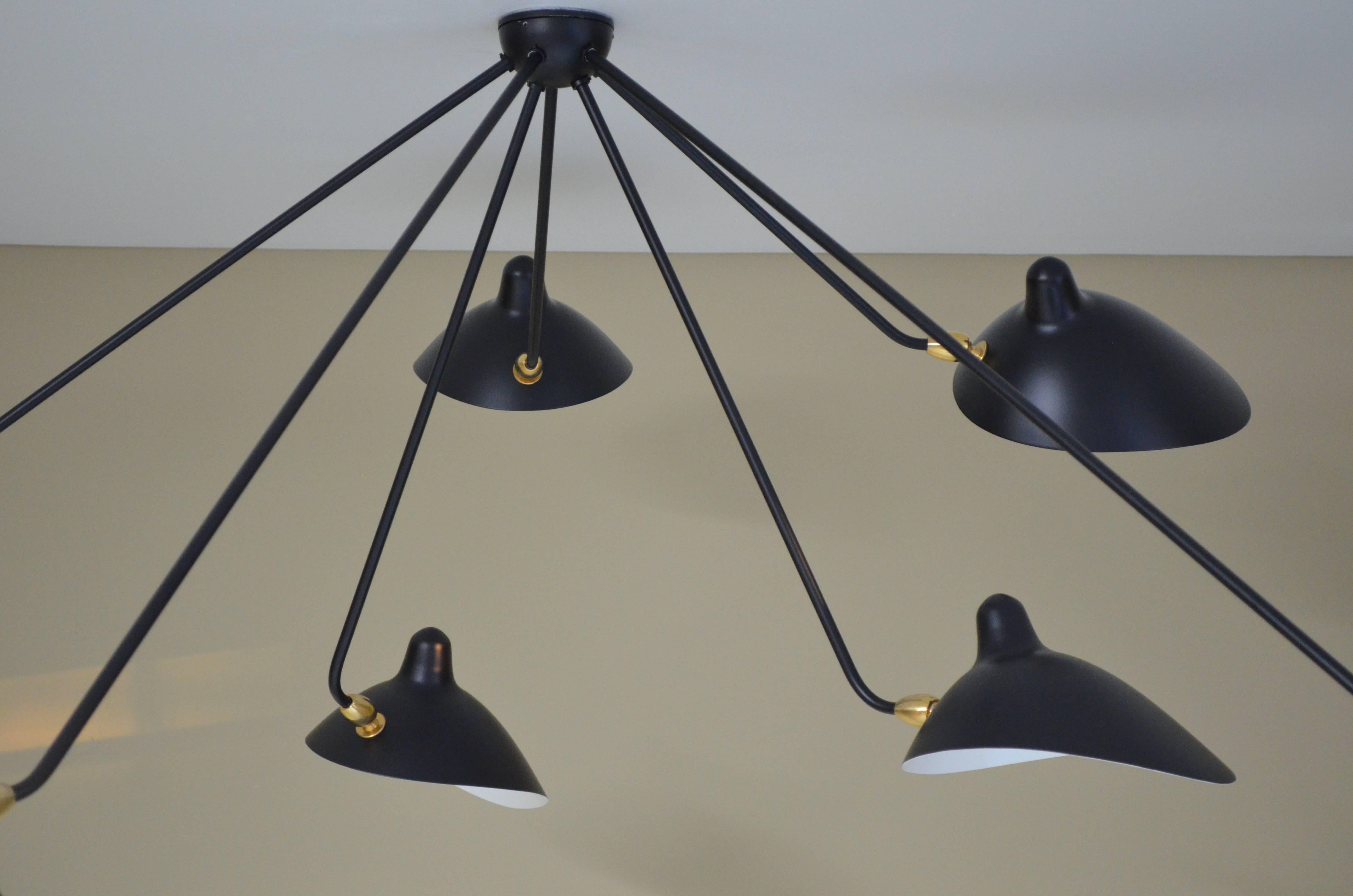 This lamp with rotating heads on seven fixed arms is a statement as much as it is a ceiling lamp - one that will command the conversation.

Available in white or black. Brass swivels connect the shades.

COLOR OPTION
Available in Black or