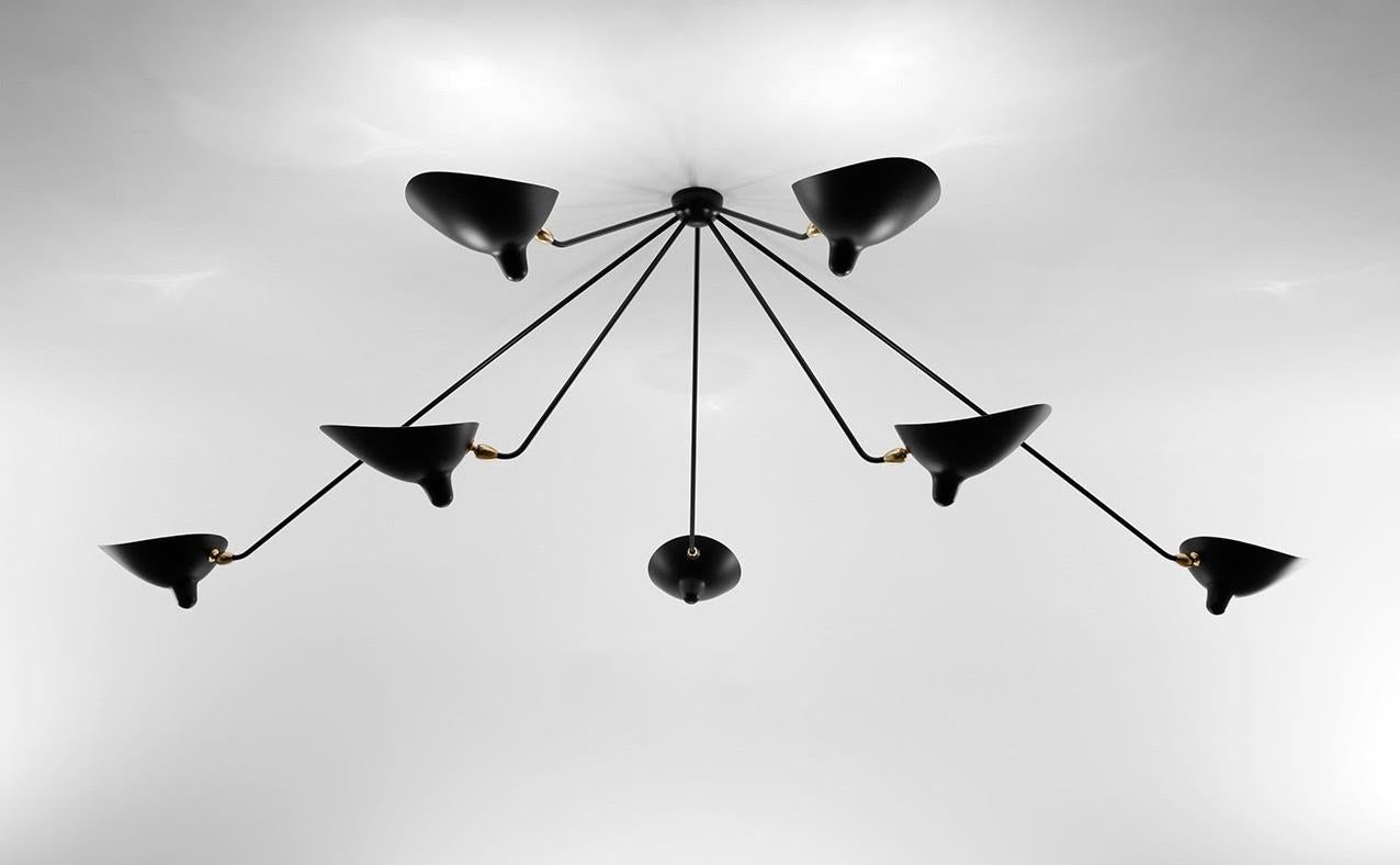 This lamp with rotating heads on seven fixed arms is a statement as much as it is a ceiling lamp - one that will command the conversation.

Available in white or black. Brass swivels connect the shades.

COLOR OPTION
Available in Black or