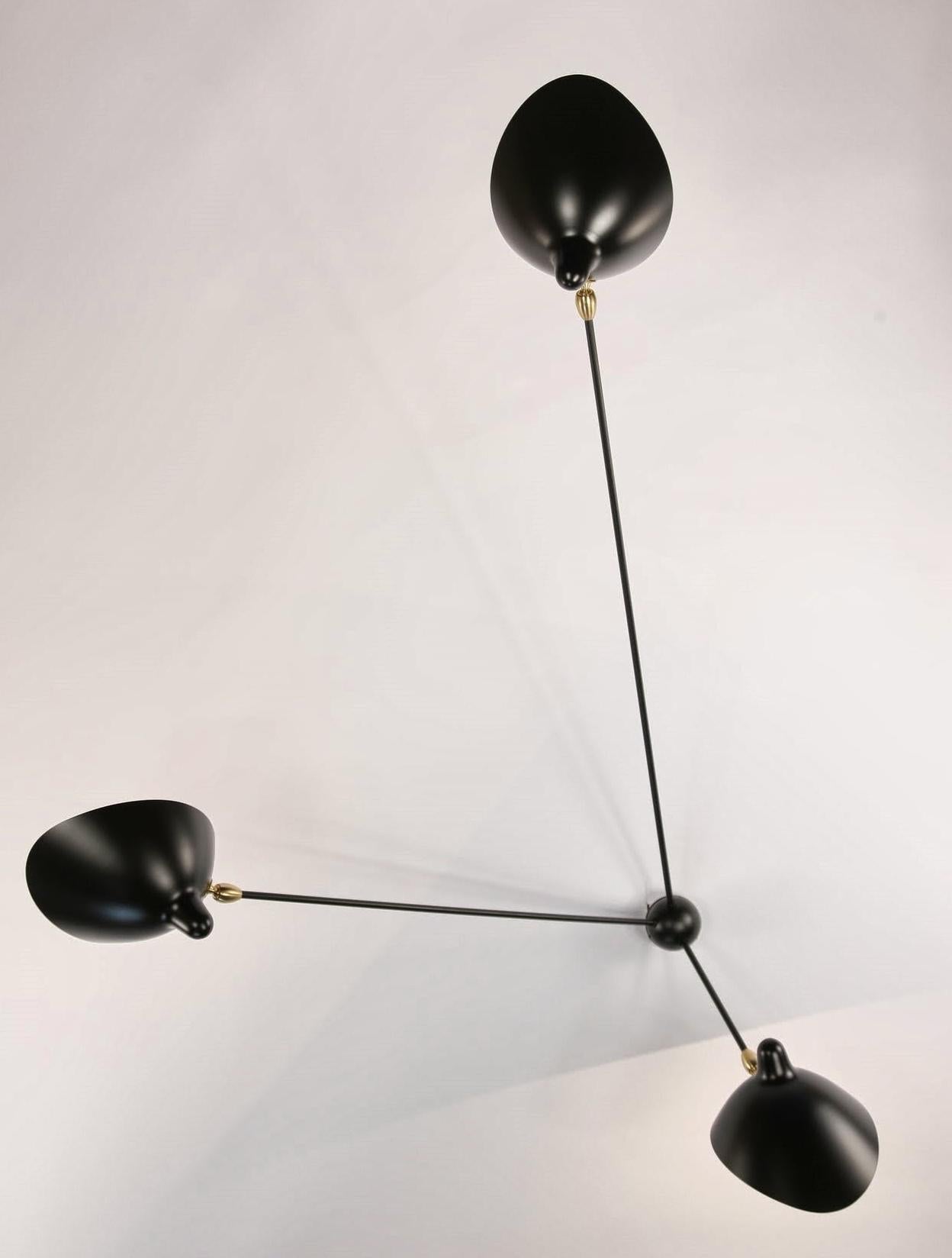 With three stationary arms projecting from the central mount into the room, this lamp becomes a reference point while illuminating the surroundings. Each lamp head tilts and revolves.   Brass fittings.
Available in white or black.

DIMENSIONS SPIDER