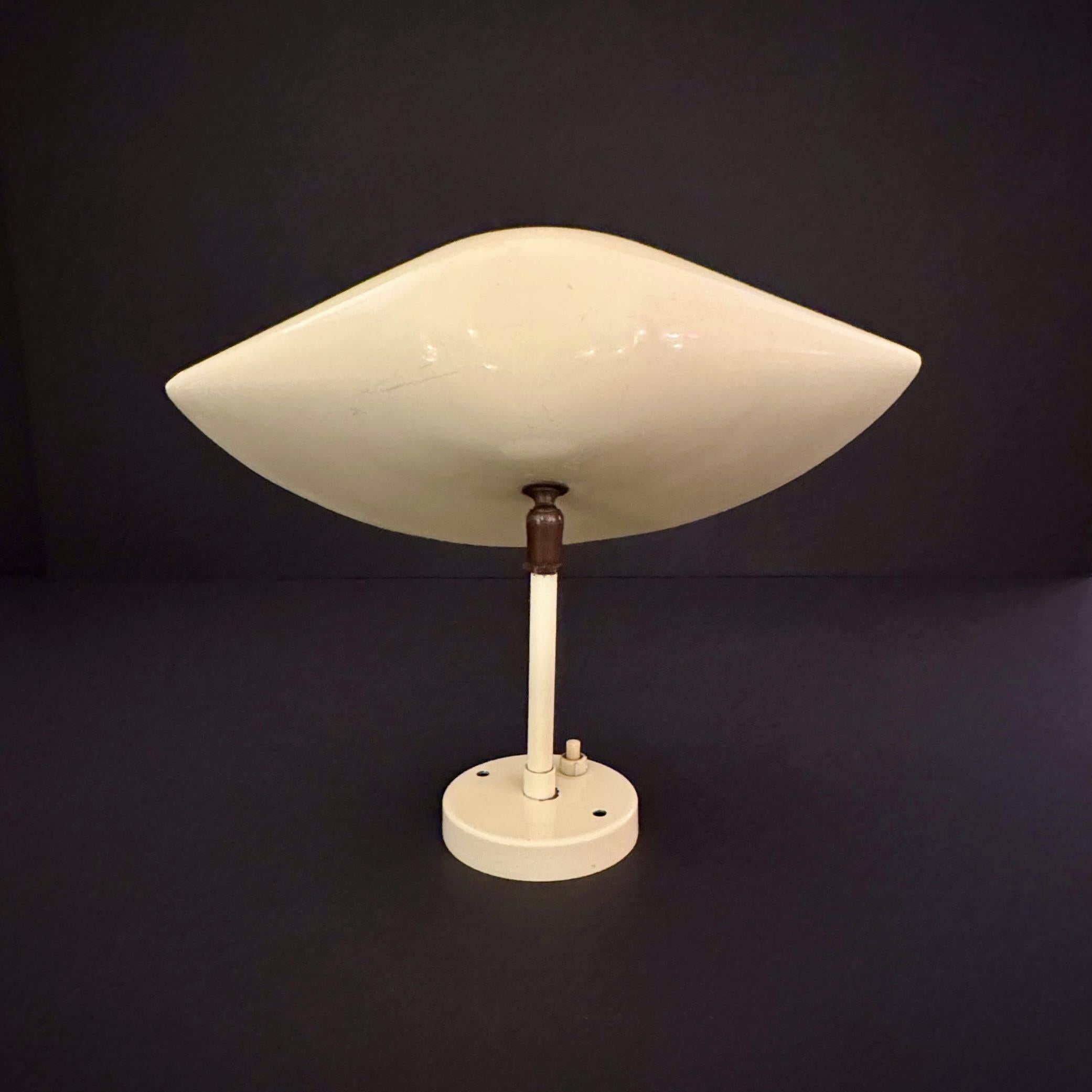 Early example of Serge Mouille wall lamp designed by the French designer Serge Mouille (1922-1988) in the early 1950s. Renowned for his minimalist, sculptural lighting designs, Mouille's pieces are celebrated for their elegance, functionality, and