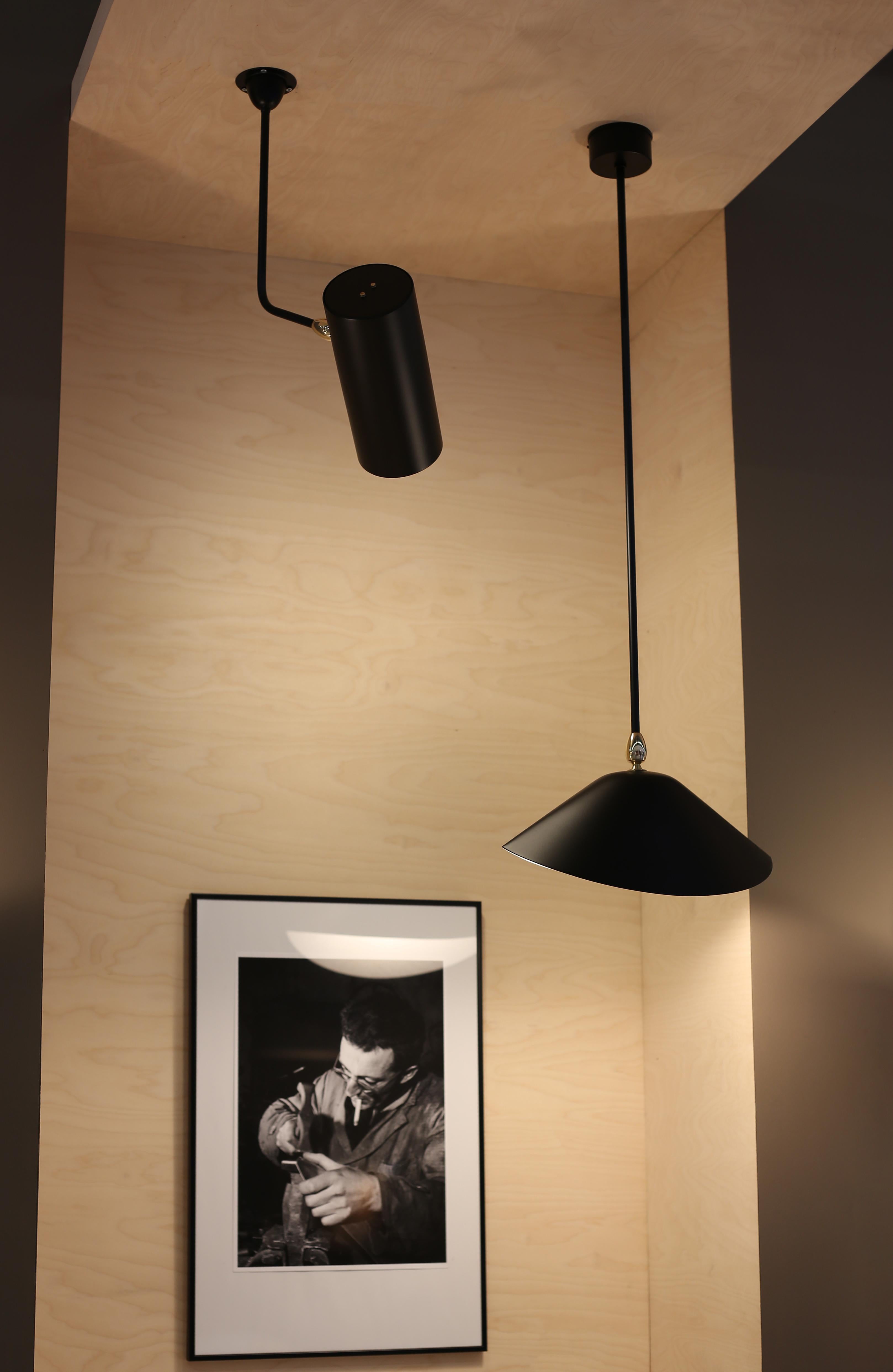 Serge Mouille 'Tuyau' ceiling lamp in black.

Originally designed in 1955, this iconic ceiling lamp is still made by Edition Serge Mouille in France using many of the same small-scale manufacturing techniques and scrupulous attention to detail,