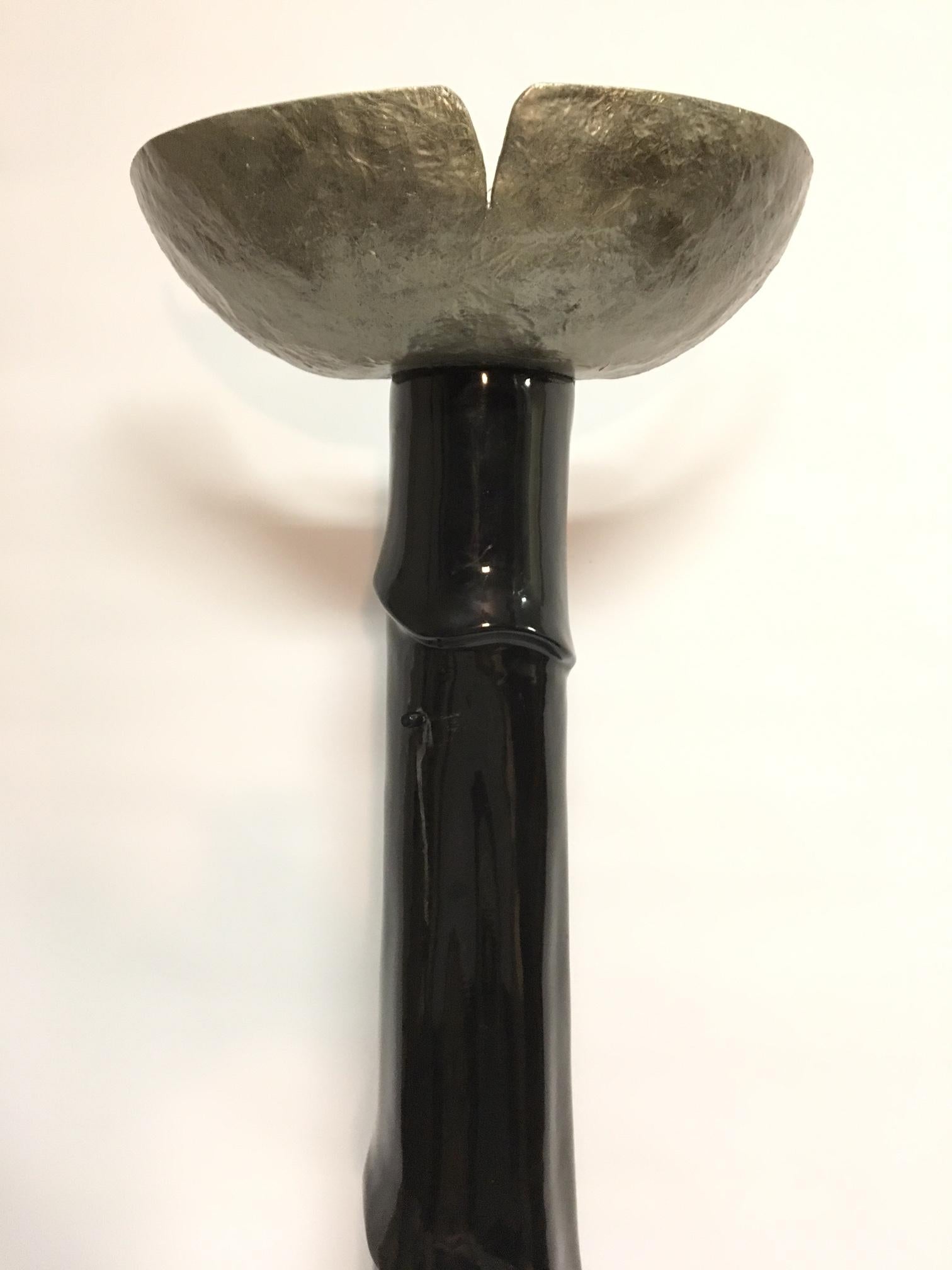 Unusual sculptural floor lamp designed to stand against a wall. Tall base with carved drape form with silver shade. Made of cast resin. Holds 2 standard light bulbs. Stands 74.5