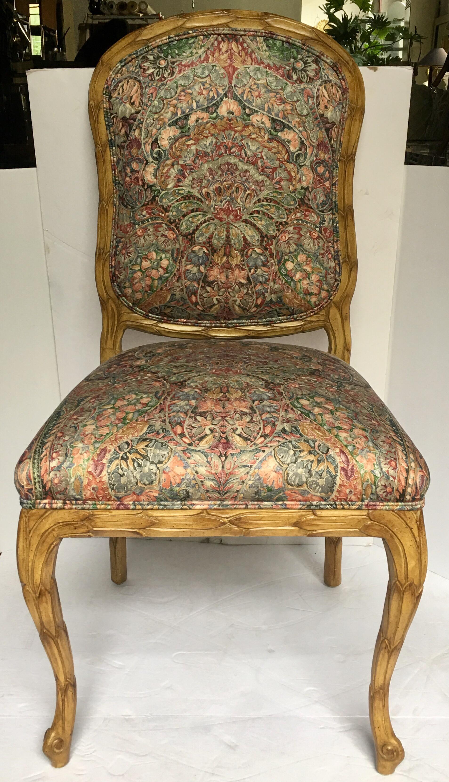 Hollywood Regency style accent or desk chair in the style of Serge Roche. This Louis XV style chair features a carved palm leaf design and original paisley upholstery with a contrast moire faux bois fabric on back, circa 1970s.