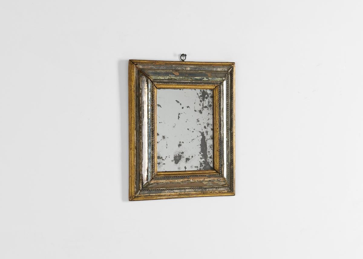 Rare rectangular giltwood mirror with layers of aged mirror around edges. Label on back from l'Exposition Internationale du cadre du XVème au XXème siècle, April 1931 at Galeries Georges Petit, Paris.
