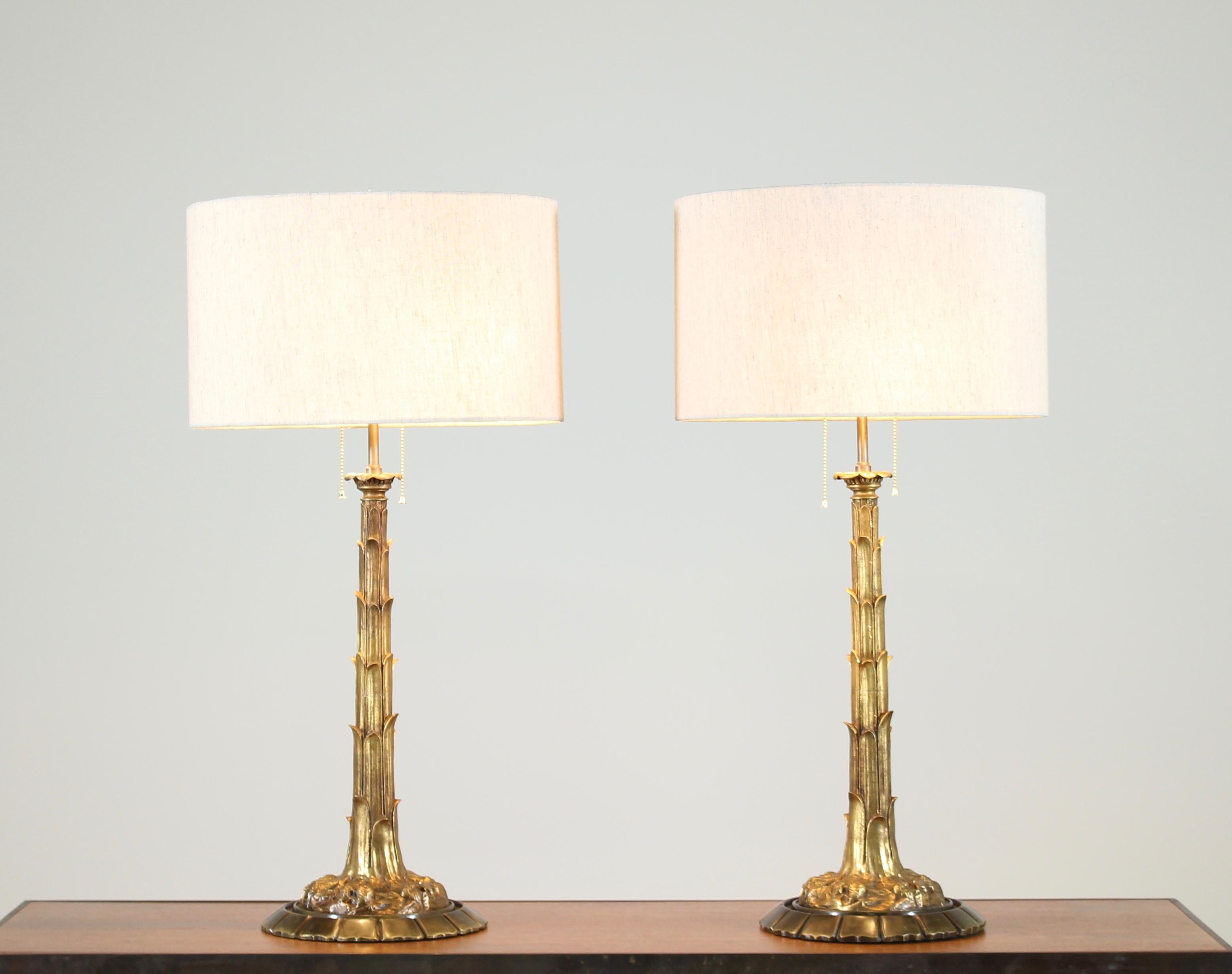 Sophisticated, pair of 1940s French bronze-doré palm tree table lamps mounted on contrasting bronze bases. These wonderful and high quality lamps bring to mind the iconic designs of the magnificent French designer Serge Roché. Wired and in working