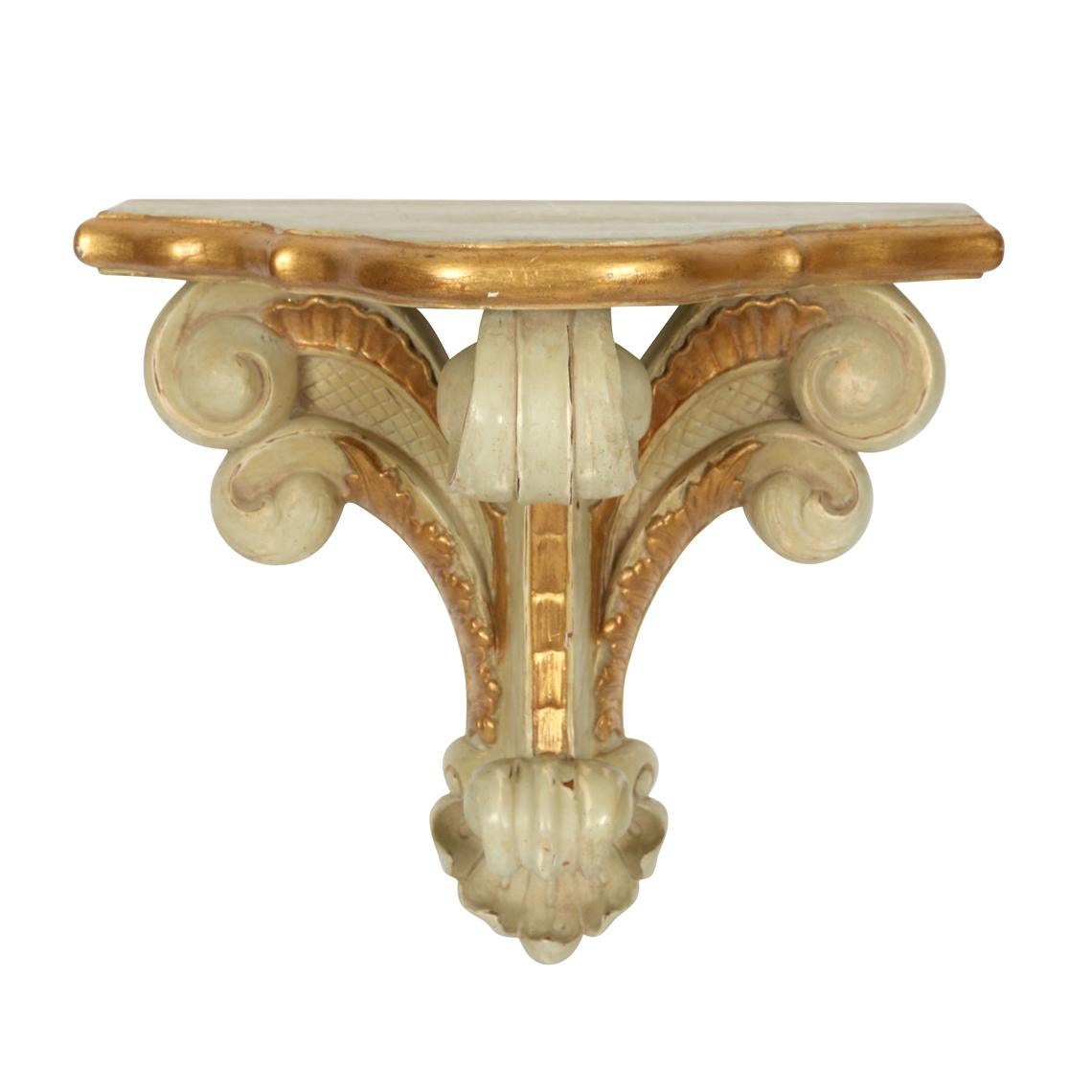 Carved wall brackets in the style of Serge Roche with scroll form and brushed gilt finish.