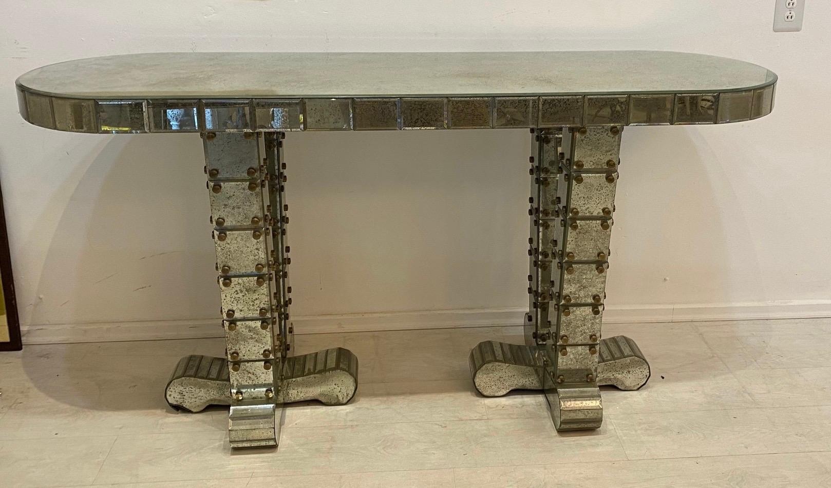 A pair of highest quality mirrored consoles with beveled mirrors and bronze elements… The design and execution of these consoles Are in the style of 1940s French designers.