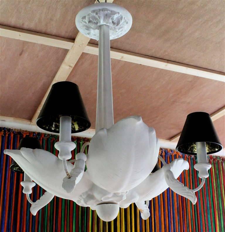 A large period chandelier, there are lights in each leaf and four lights under small shades. Needs to be rewired.  Edward Krumpe (1909-2004) was the premier mid century source of Serge Roche style lighting.  In 1972 Sirmos Lighting was formed