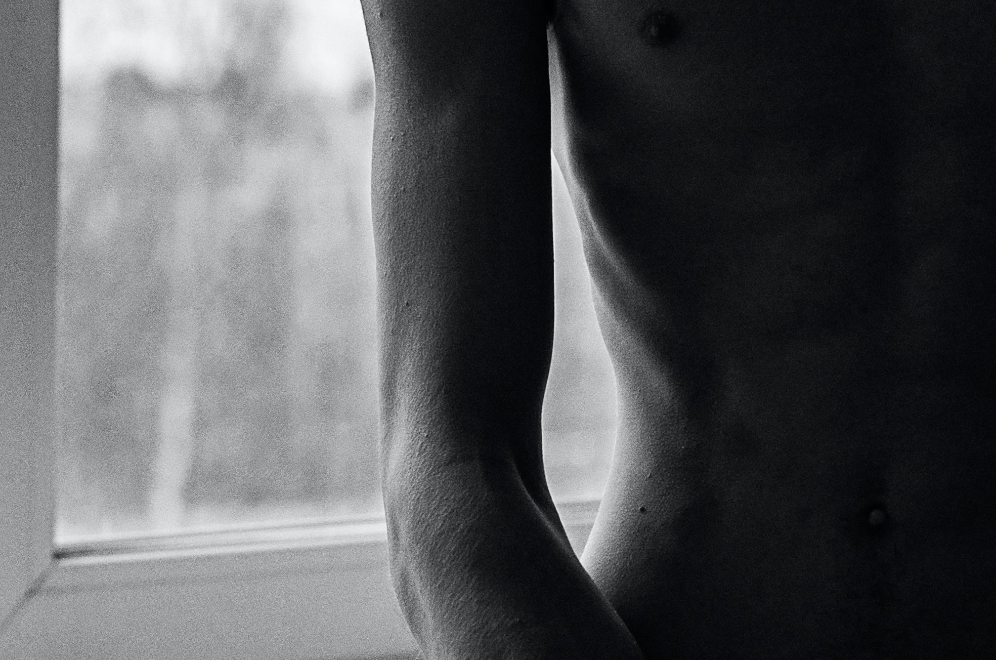 A signed Certificate of Authority will be included with all photographs. A nude boy faces the viewer siting in front of an open window. 

This impression is printed on Hahnemuhle archival paper. Hahnemühle FineArt, Inc. is a paper manufacturing