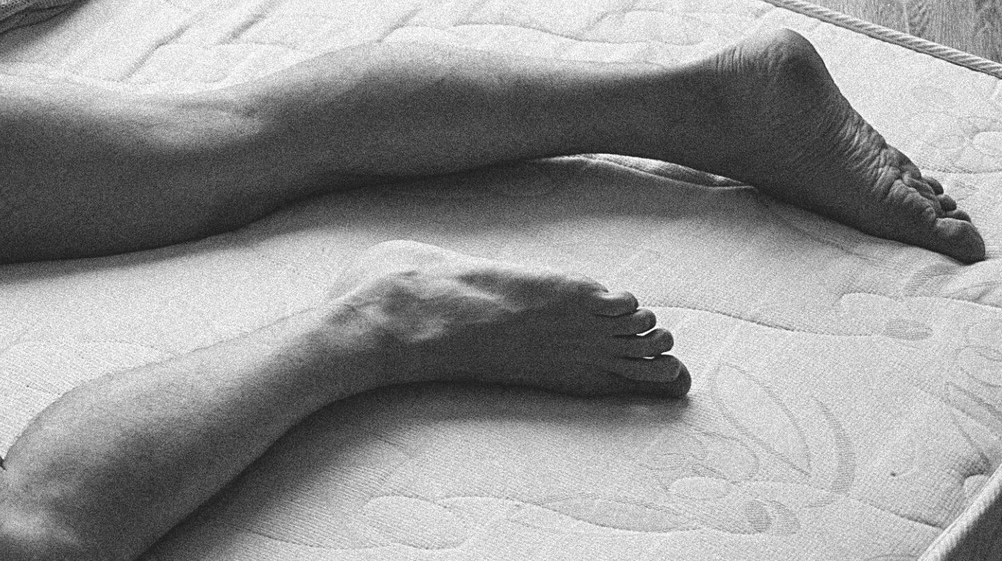 Goshen, Boy on Bed (Seductive youth splayed across mattress) - Photorealist Print by Sergey Vinogradov