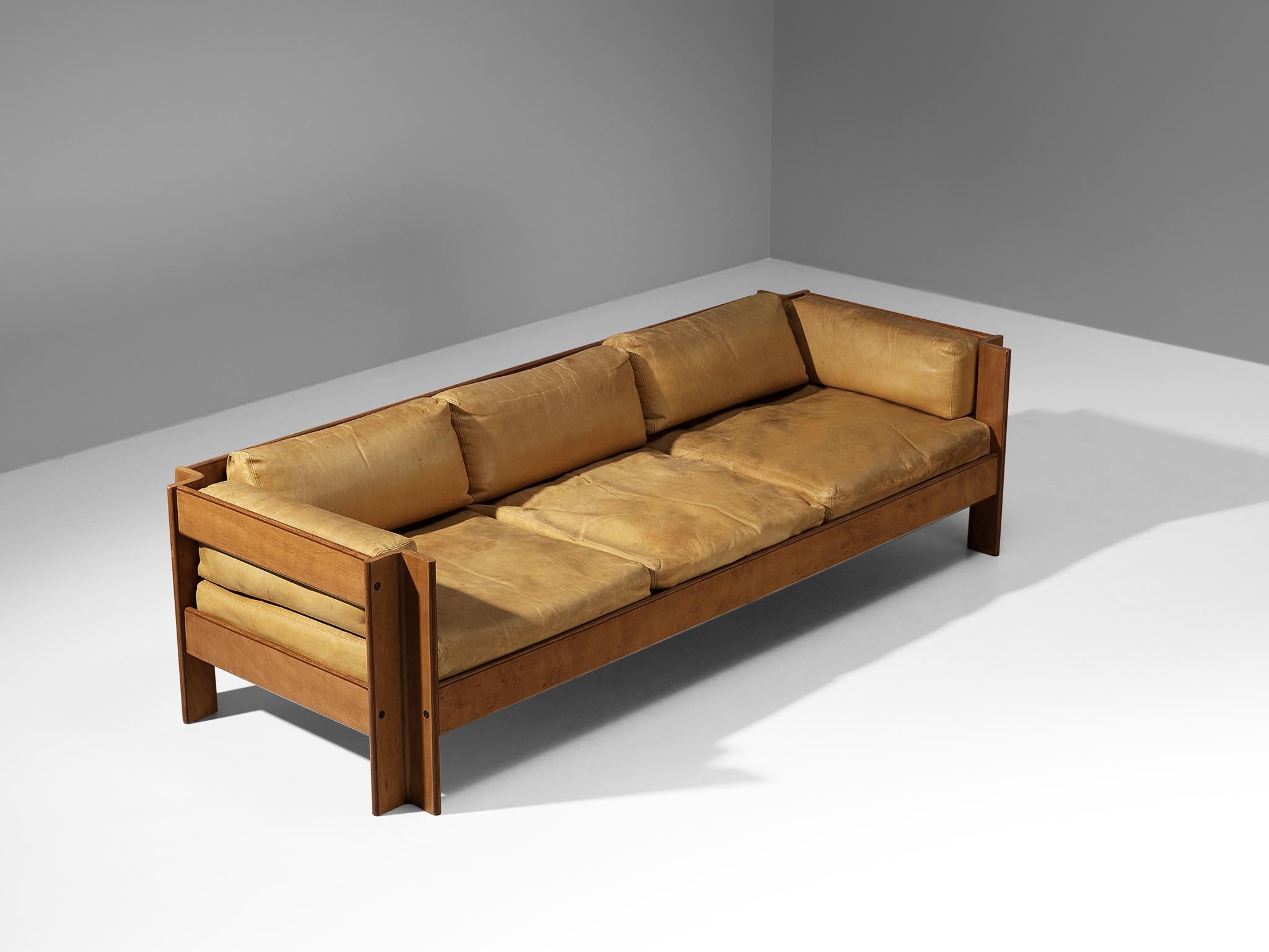 Sergio Asti for Poltronova, sofa model 'Zelda', leather, walnut, brass, Italy, 1962. 

This well-executed sofa features a sculptural wooden frame composed of cut-out angles that contribute to the sofa's architectural appearance. The design has an