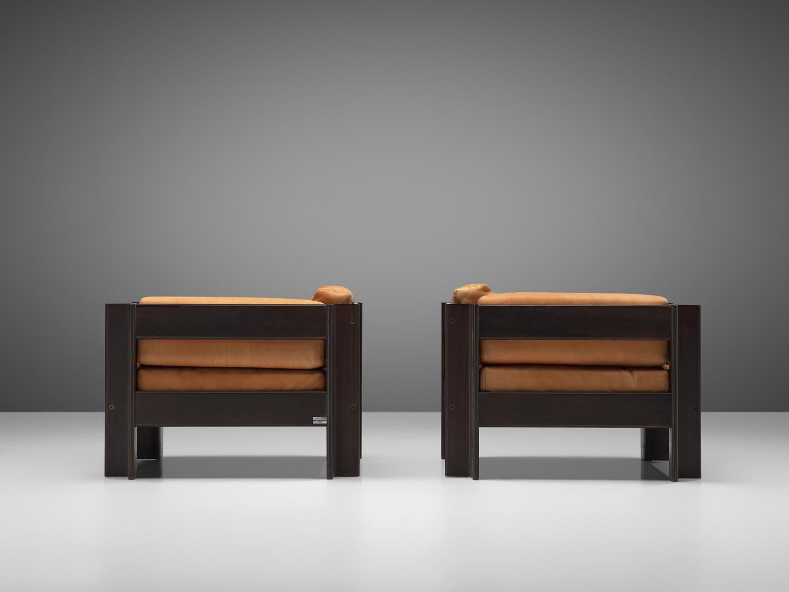 Sergio Asti for Poltronova, 'Zelda' set of lounge chairs, leather and darkened wood, Italy, 1962.

Beautiful pair of lounge chairs designed by Sergio Asti for Poltronova. The chairs are made with a dark wooden frame and terracotta/cognac colored