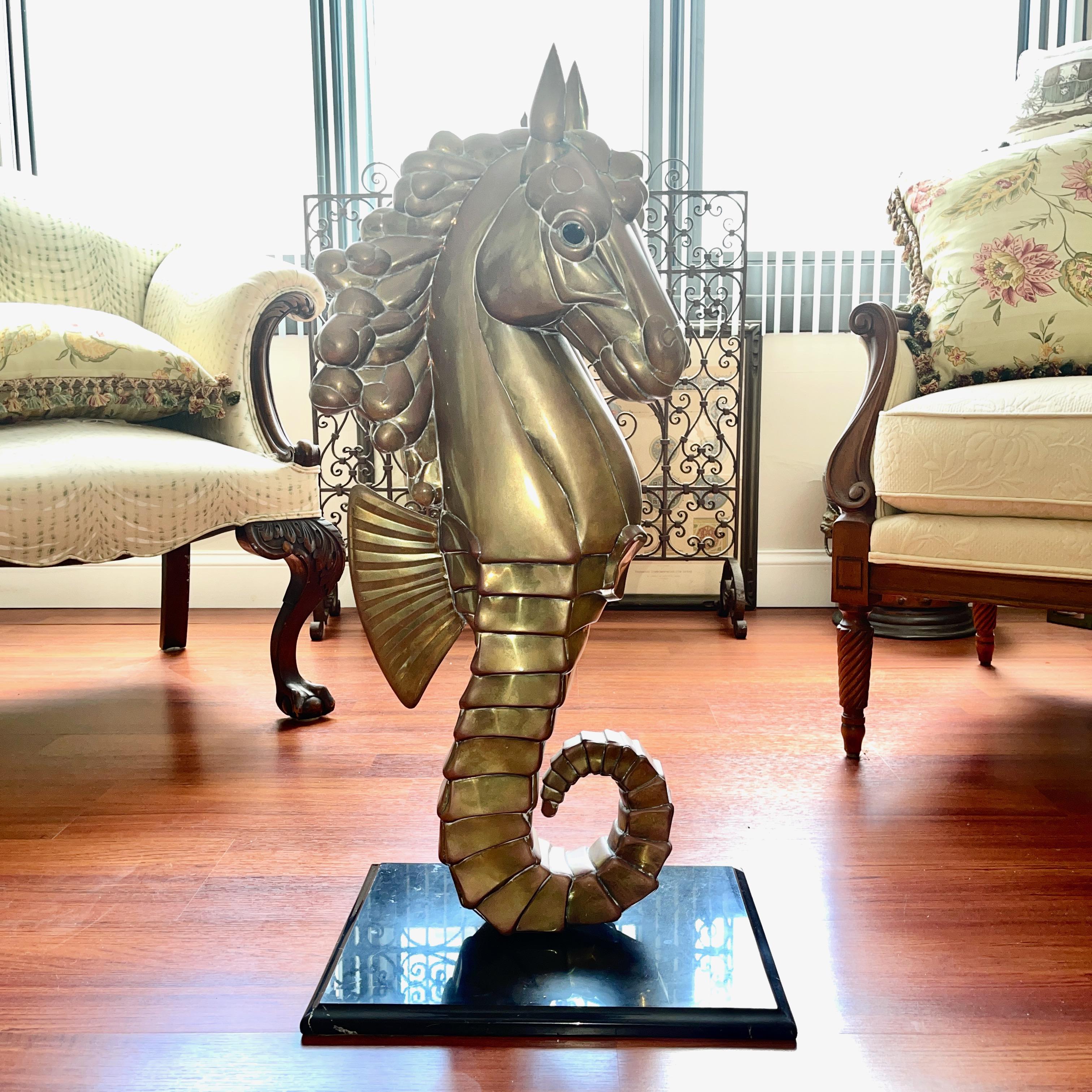 Very rare sculpture of a seahorse by Sergio Bustamante in brass standing on a marble base.
The brass seahorse lifts up off an aluminum post mounted to the marble base to hold it in upright position
Seahorse itself is 31 inches high by 6 inches wide