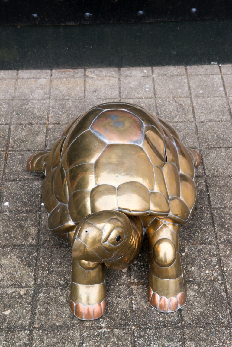 Mid 1970s brass and copper turtle sculpture by Mexican artist Sergio Bustamante. 
Turtle back has one dent.