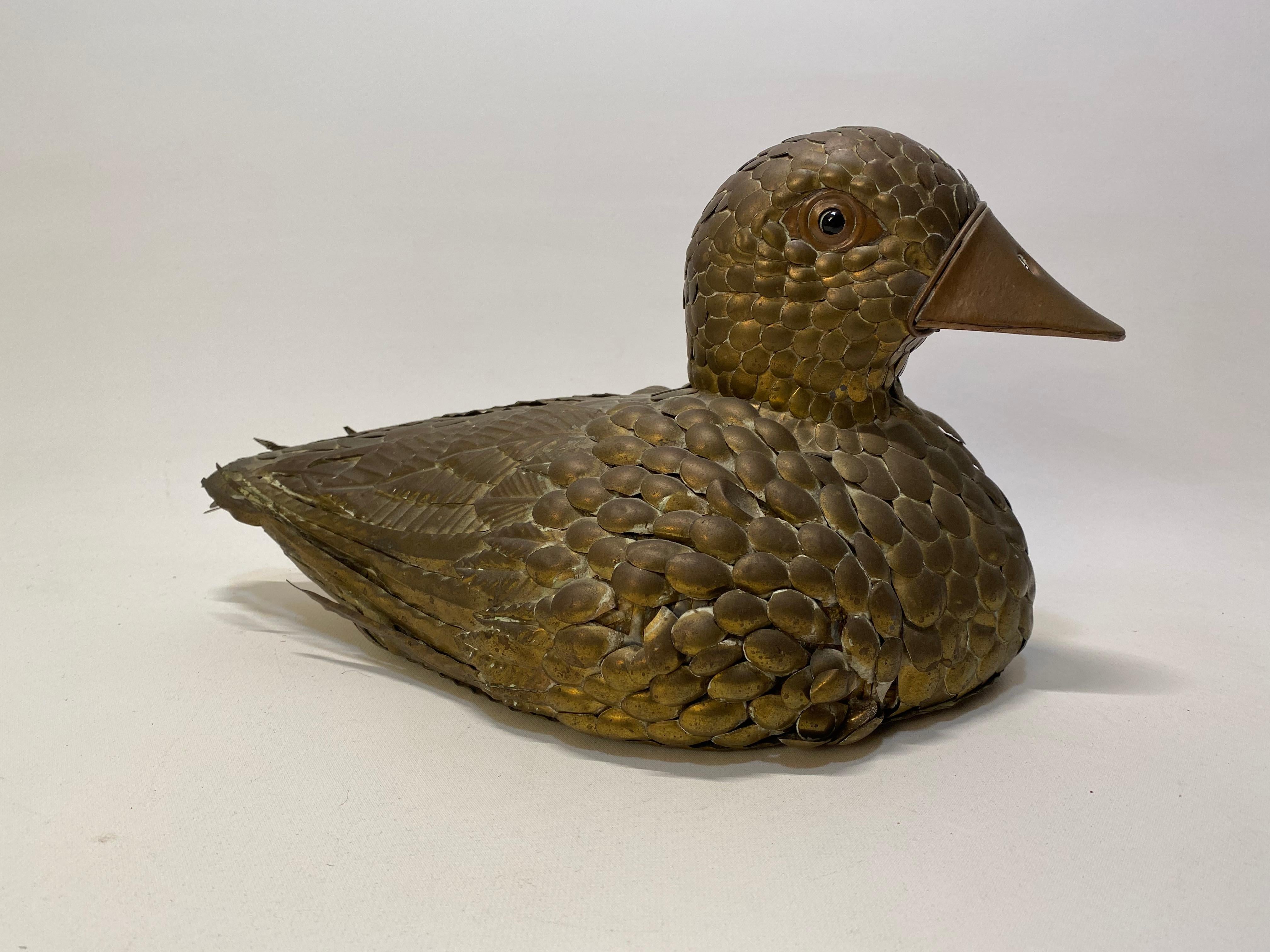 Sergio Bustamante copper and brass duck. Wonderful lifelike detailed metal sculpture of a duck. Signed on bottom with red and gold foil label. Good condition with a few feathers missing (see photos), tarnish and patina. No major scratches or