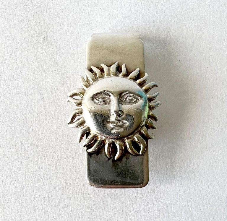 Sterling silver money clip with sun face decoration created by Sergio Bustamante of Mexico. Clip measures 2