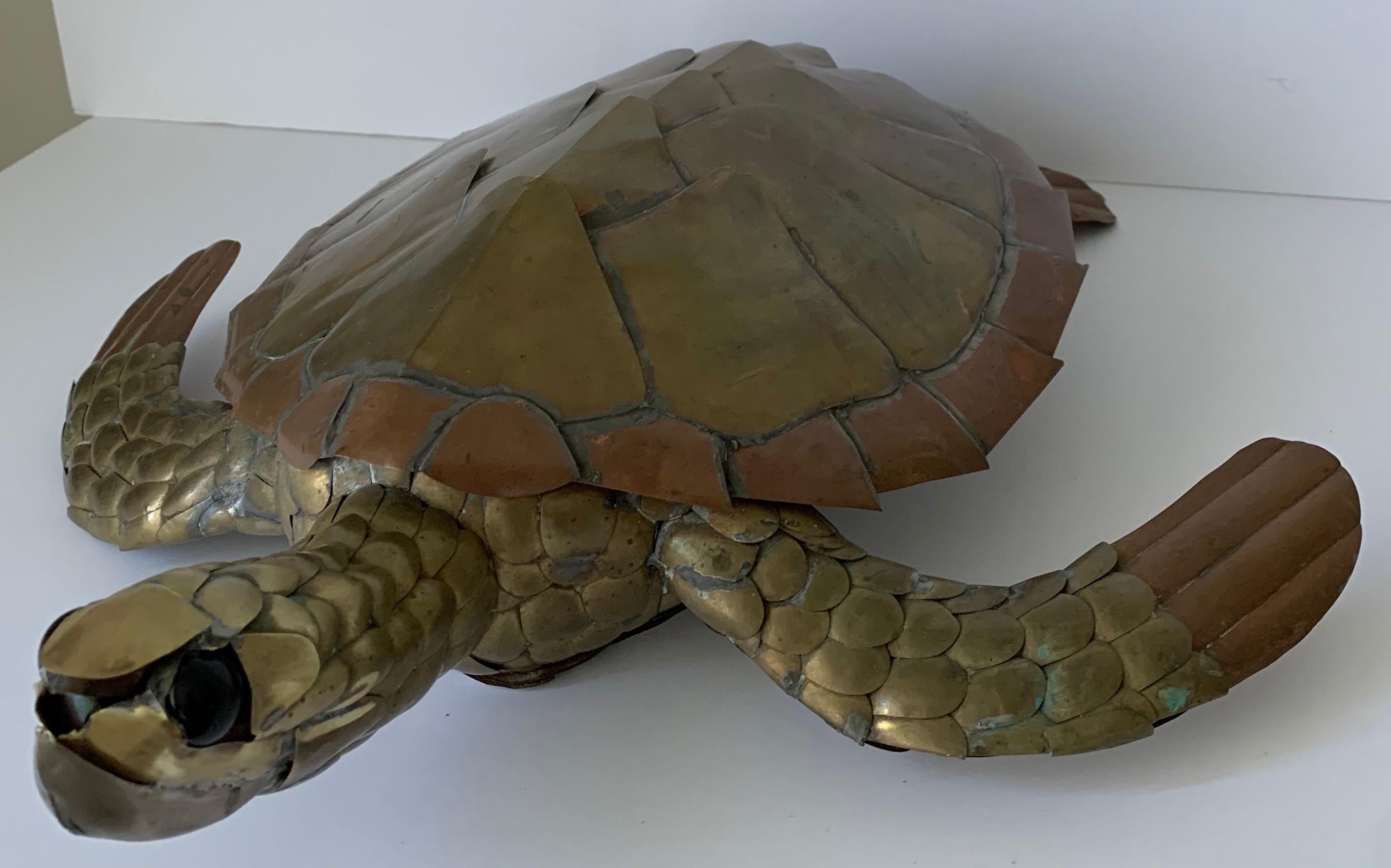 Sergio Bustamante mixed metal sea turtle. Brass with copper and chrome accents. Round glass eyes. This piece is not signed.