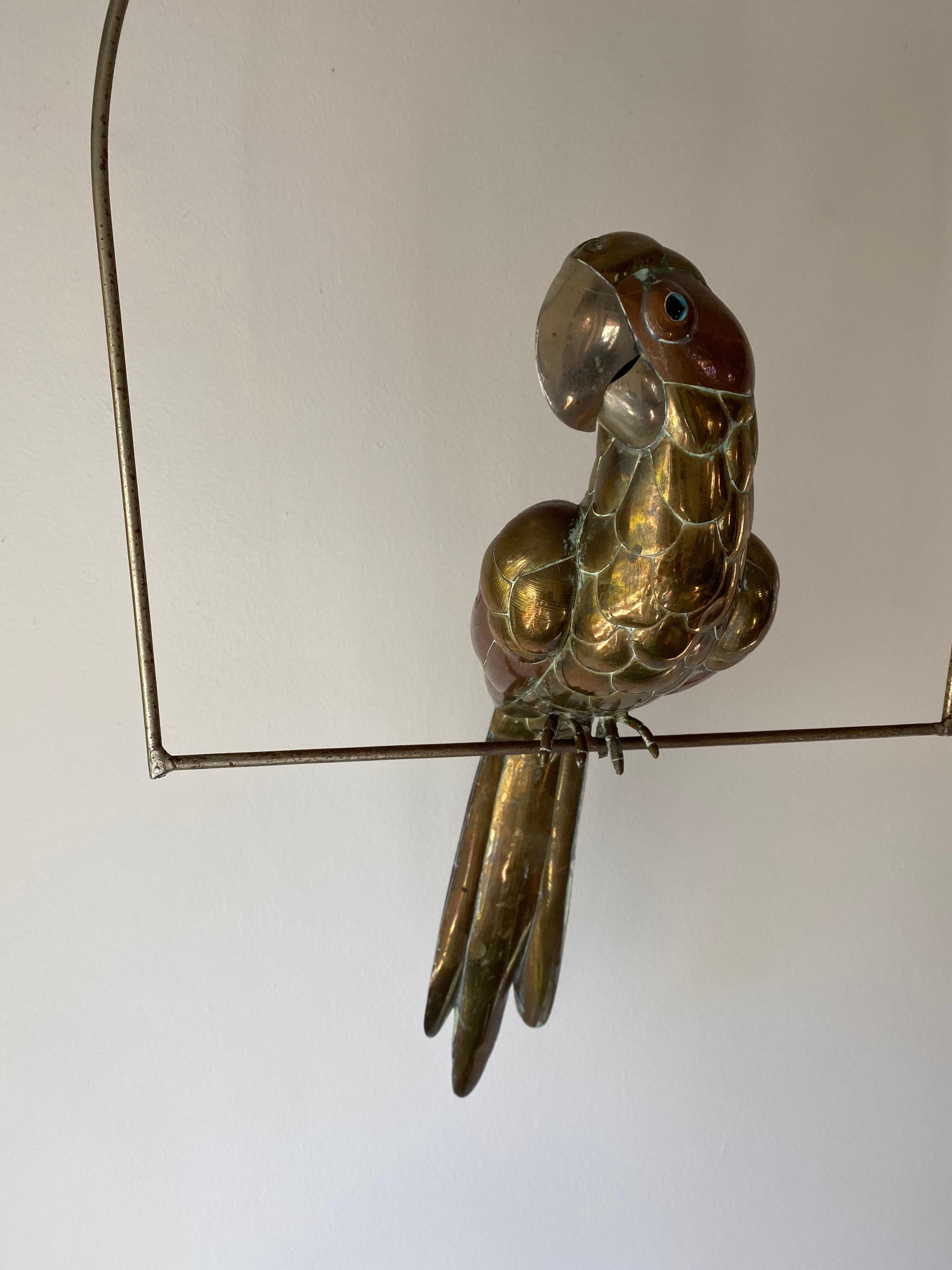 A Sergio Bustamante perched parrot in brass and copper. Lovely patina to piece.