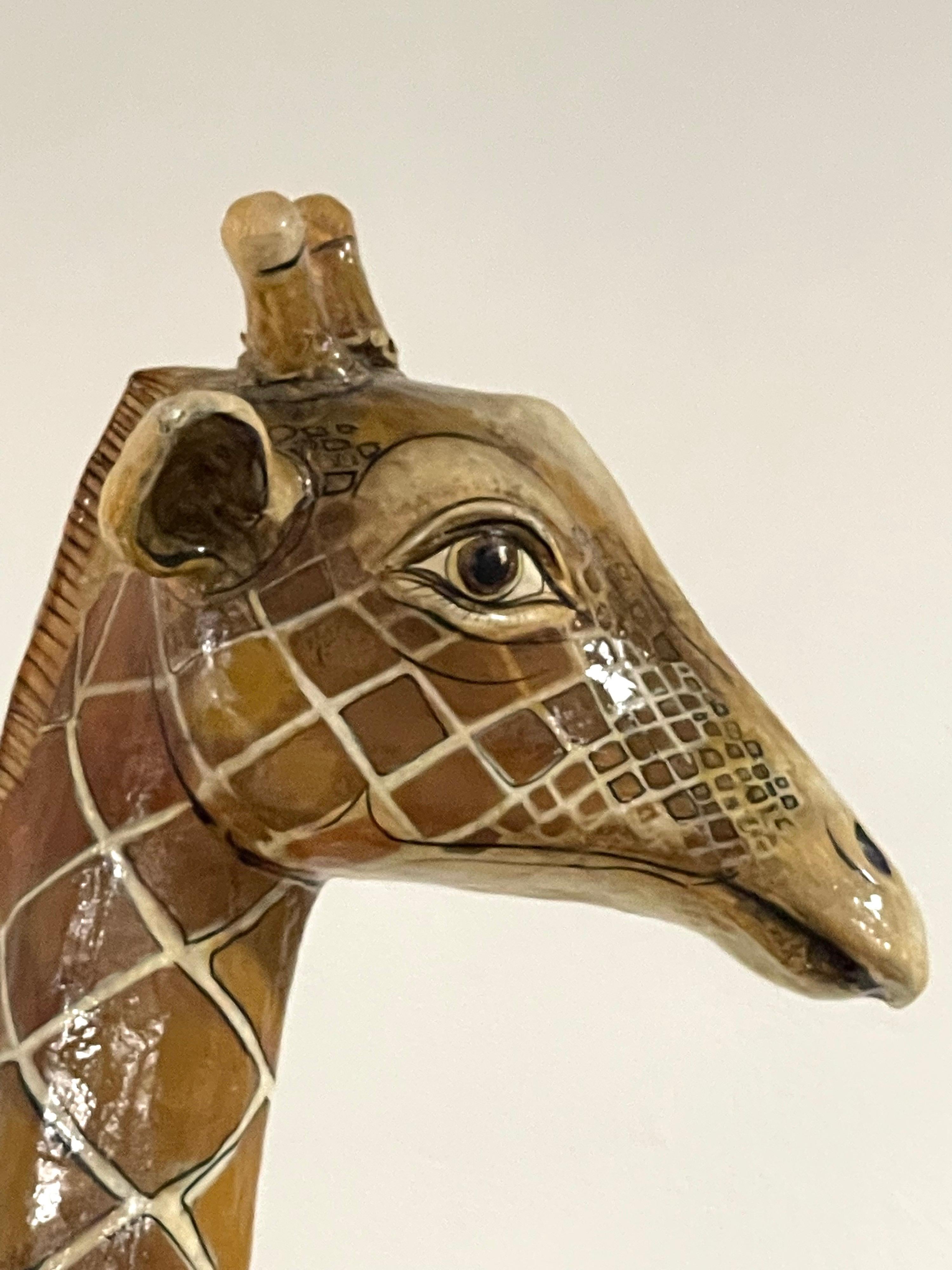 A beautiful large twin headed Papier Mache giraffe sculpture by Sergio Bustamante from 1977. Comes with a copy of a certificate from Bustamante himself dated June 6, 1977. In good condition with a minor small crease on the underside of the