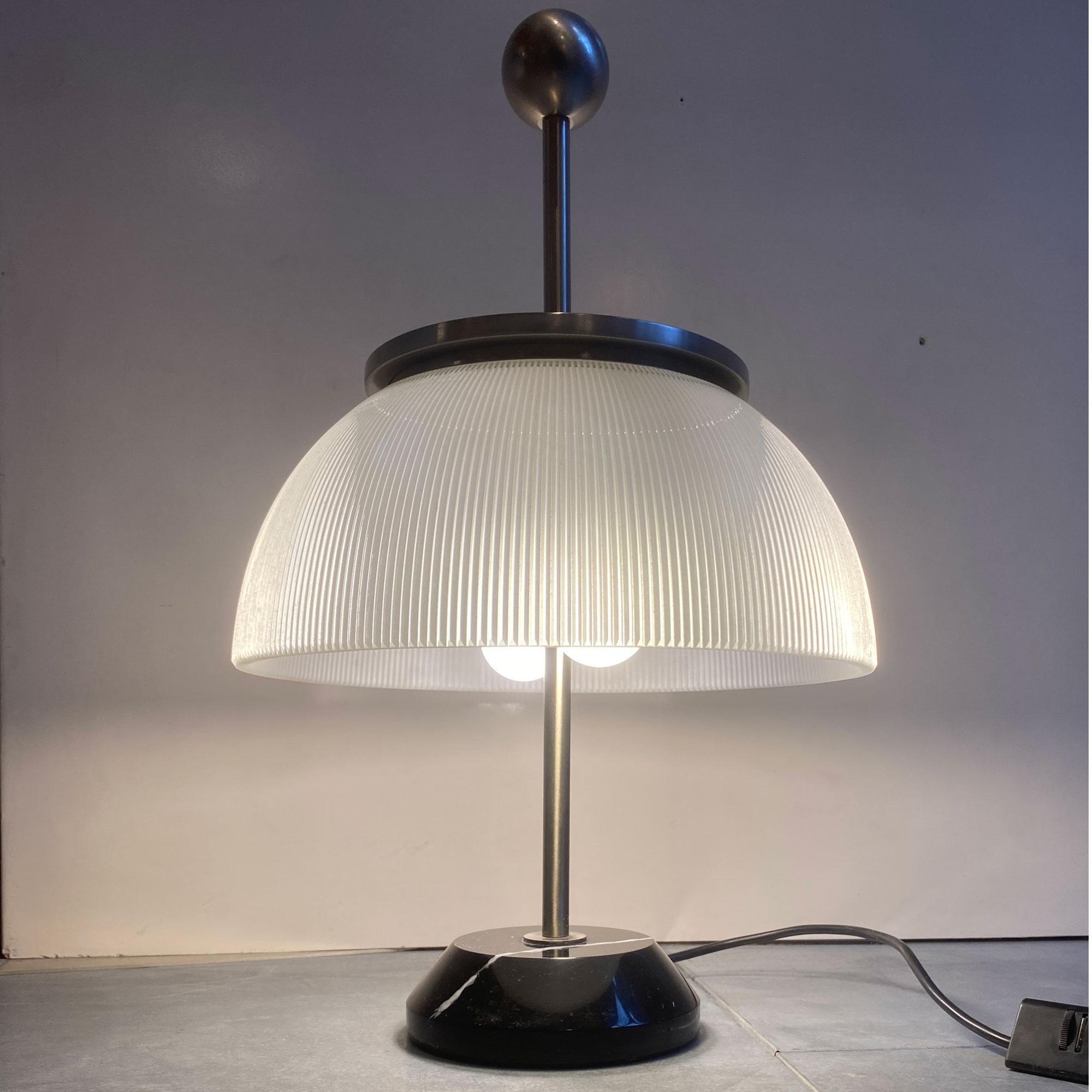 Sergio Mazza
A beautiful table lamp, combining modernity and tradition, making this piece a timeless decorative element. Black marble in very good condition, with the brand's signature present.
Alfa is the first lamp to enter the Artemide catalogue