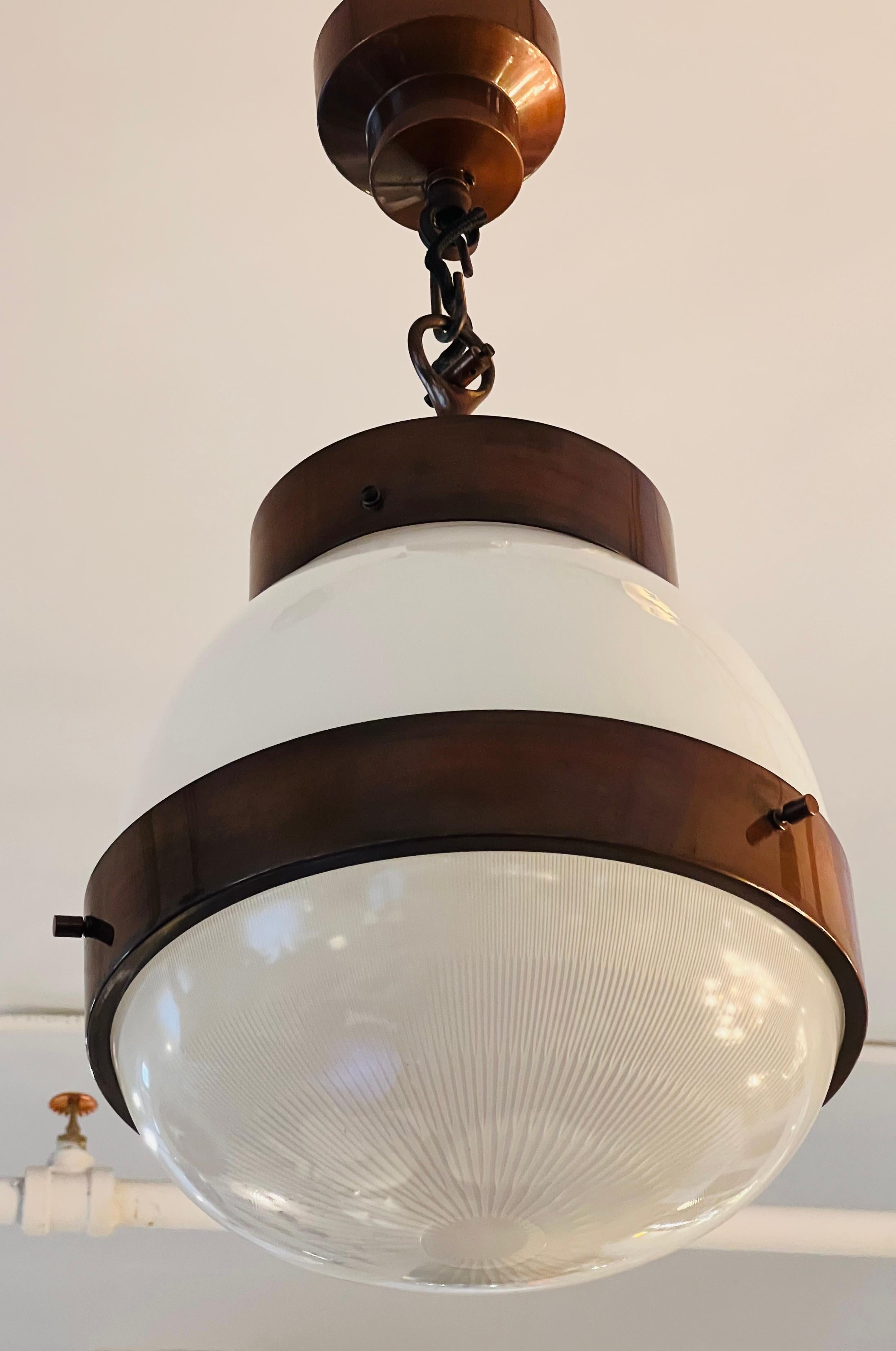 A beautiful 1960s Italian pendant lantern in a aged copper finish with two glass shades with the bottom being halothane glass. One Standard A socket 200 watts. Newly rewired.
