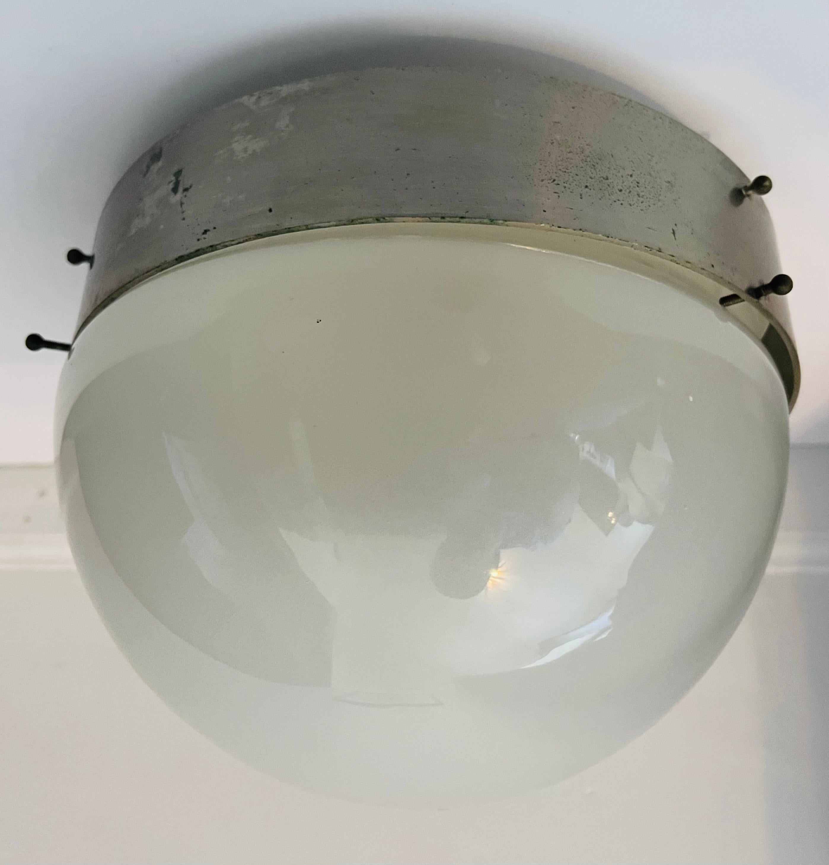 A 1960s modern industrial style flush ceiling light in aged brushed steel with a glossy white opaline glass shade. Rewired.