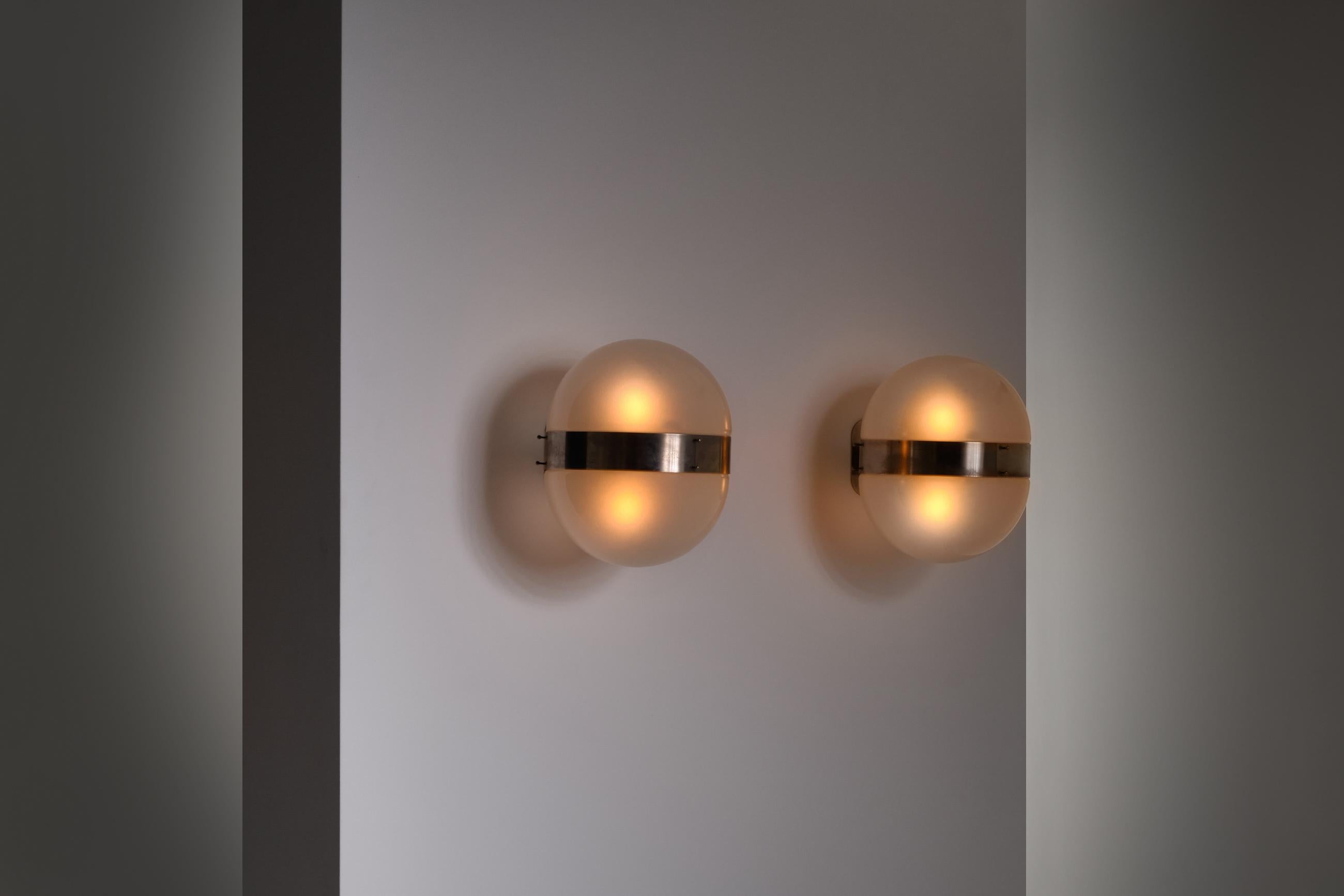 Pair of 'Clio' wall lights by Sergio Mazza for Artemide, Italy, 1960s. Frames made of nickel-plated brass, bowl shaped shades of frosted glass. Impressive architectonic appearance due to its monumental size and raw use of material. Each sconce holds