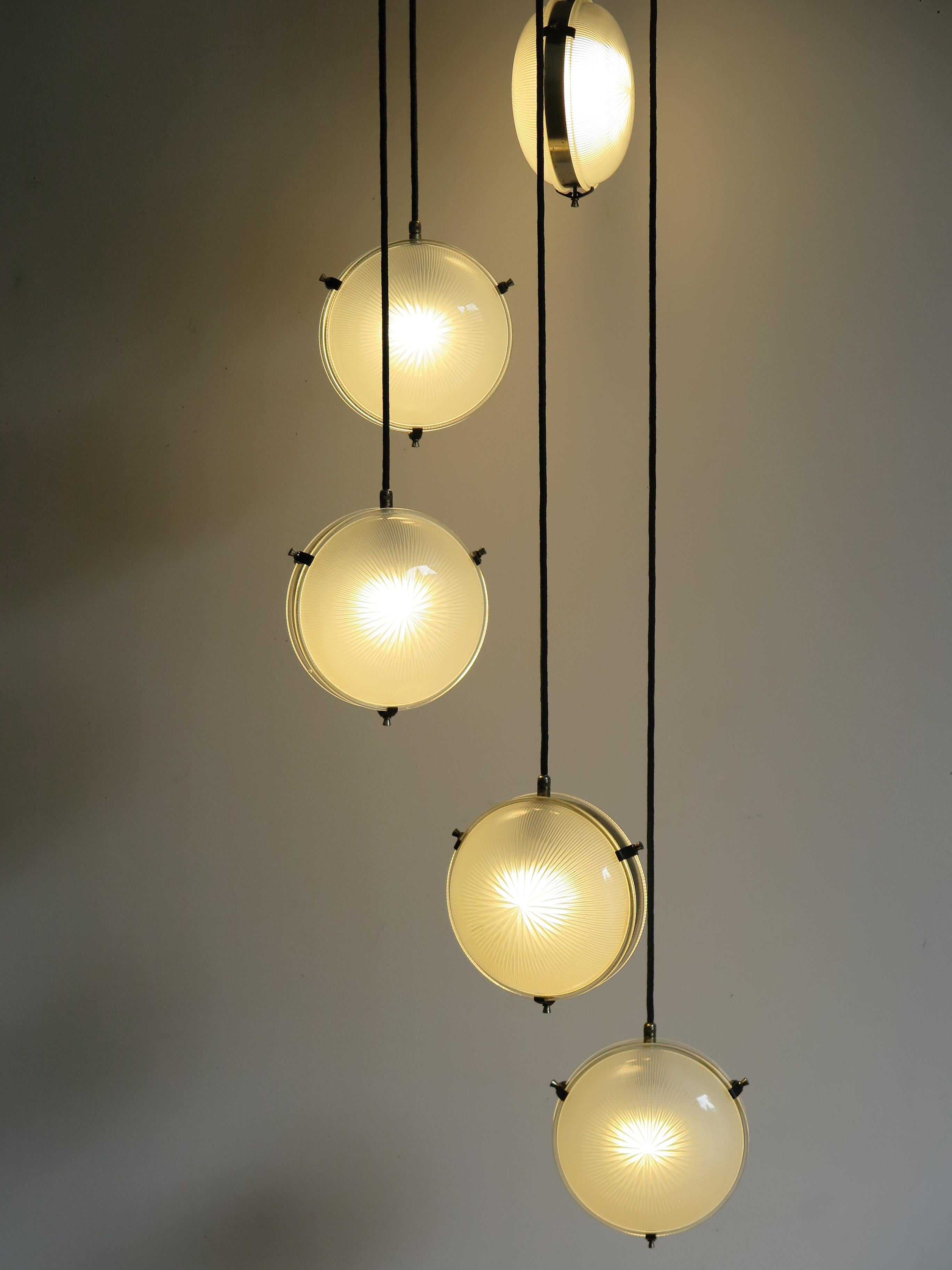 Rare and amazing ‘Delta’ five pendant lamp adjustable designed by italian Sergio Mazza and produced by Artemide, an architectural signature design by the incomparable Italian icon of modernism, executed in nickelled brass and pressed glass, Italy