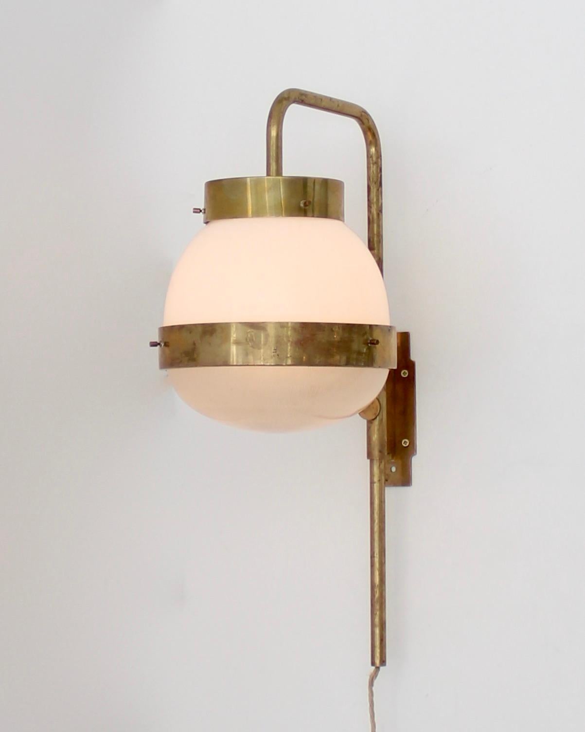 A single Sergio Mazza Italian vintage Delta sconce for Artemide.
Brass with Holophane and milk glass encircled by brass bands.
Excellent condition. 
Rewired for USA. 

 Measures: 26 in. H x 10 in. W x 14 in. D.