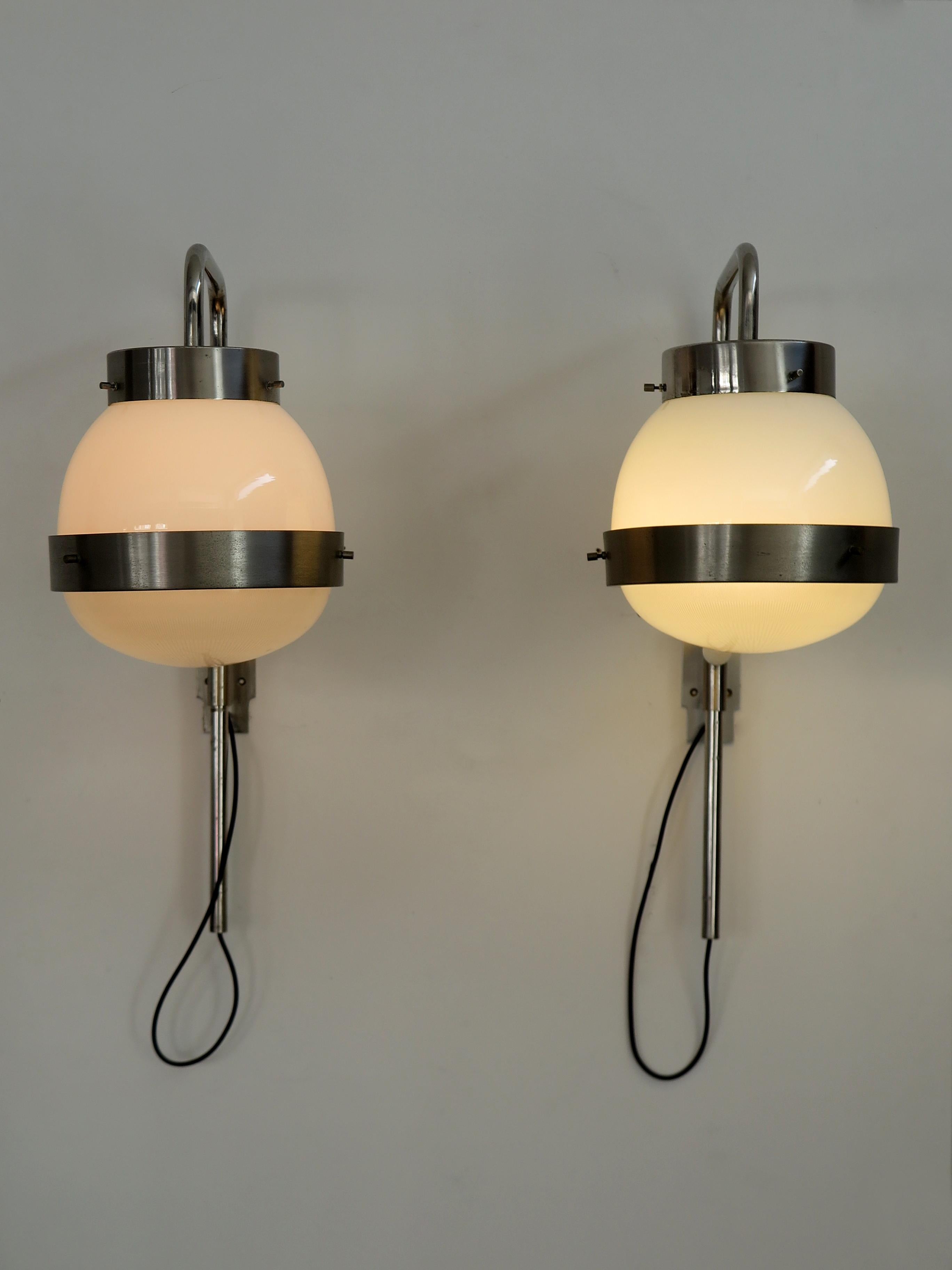 Italian amazing sconces wall lamps set ofv two model Delta designed by Sergio Mazza and produced by Artemide, adjustable in height, in nickel-plated, lower part in pressed crystal, 1960s.
XII Triennale.

Please note that the lamps are original of