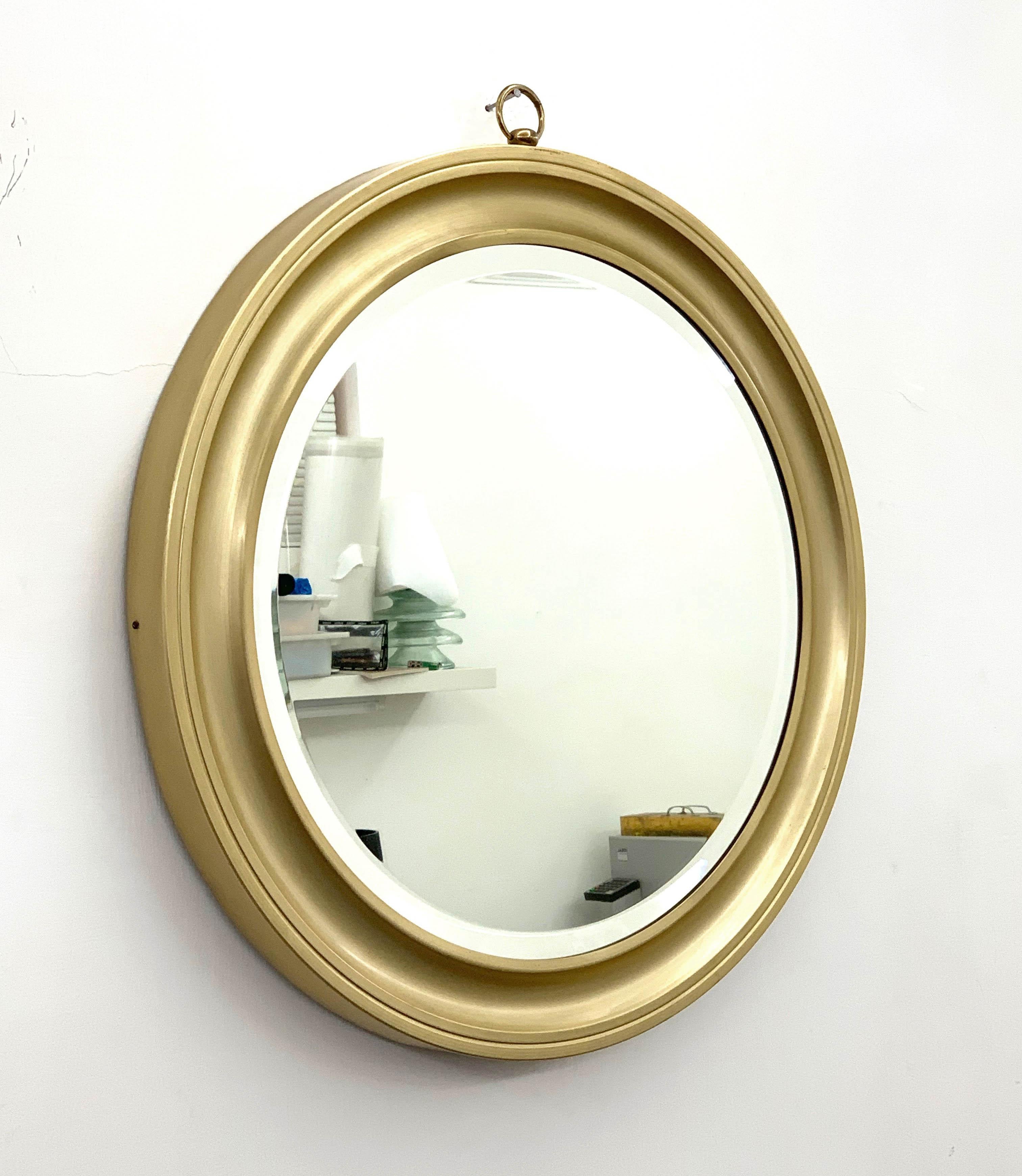 Rare and magnificent modernist mirror in gilded aluminum. The item was produced in Italy during the 1960s.

Amazing wall mirror attributed to Sergio Mazza for Artemide.

This original mirror has a concave centre that creates depth and texture in