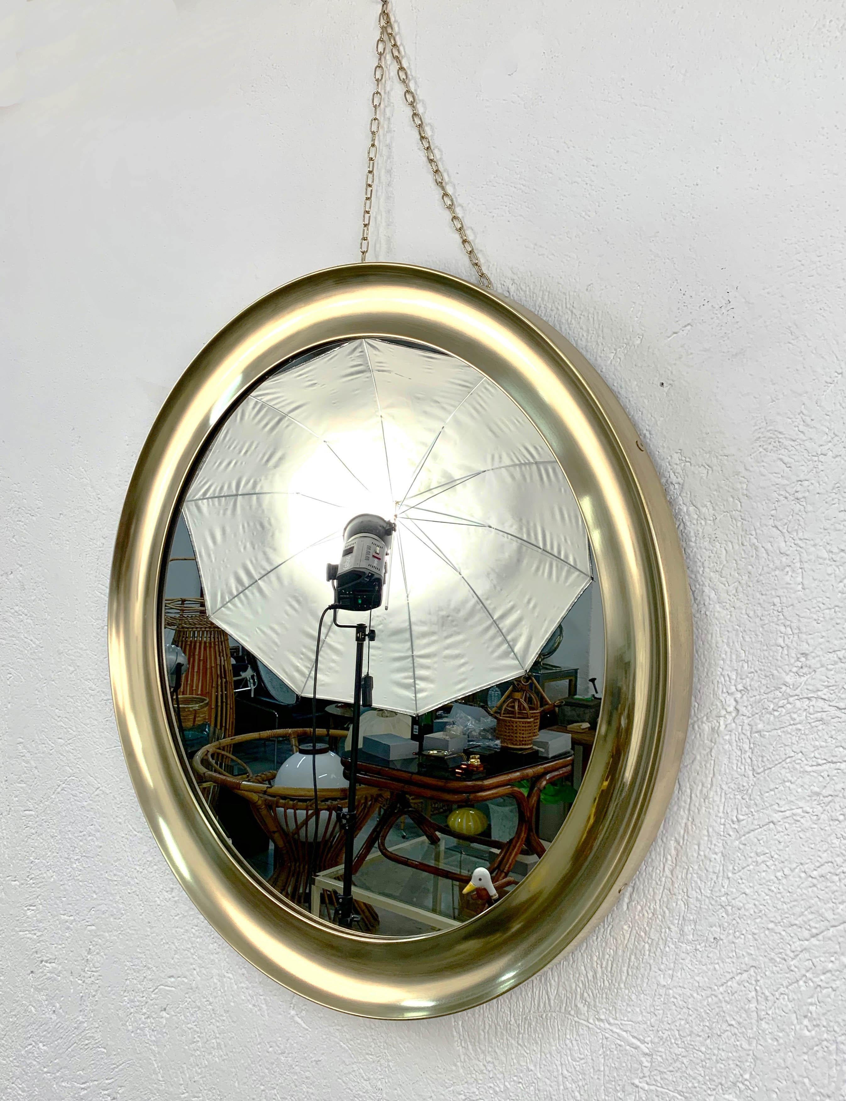 Beautiful large and vintage mirror with a 83 cm diameter produced by Sergio Mazza for Artemide during the 1960s in Italy. 

This marvelous piece is a very rare production, as it has a concave brass frame. This item enlights the room and expands