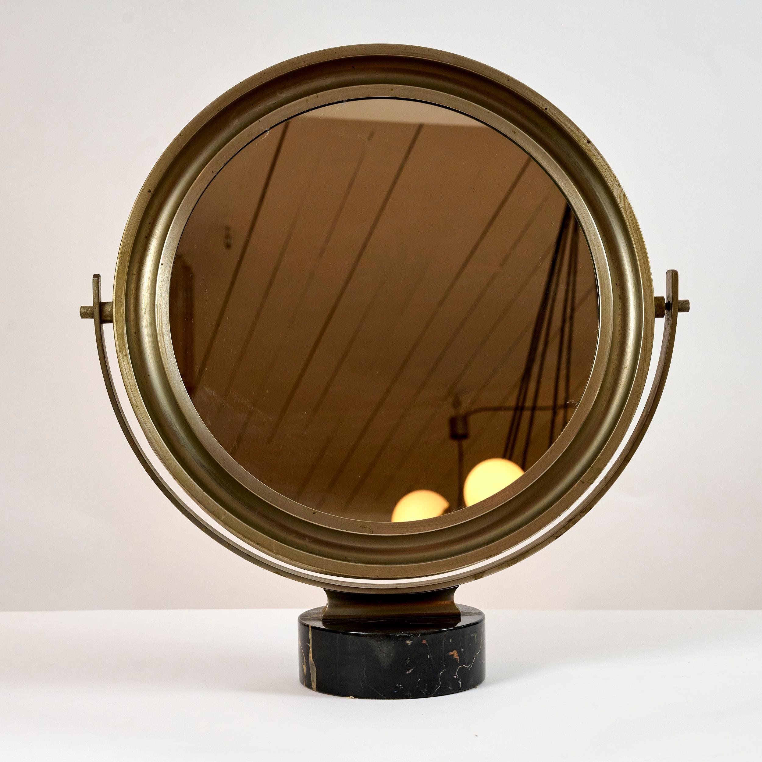 Sergio Mazza 'Narcisso' table mirror. Italy c1960.

Nickel frame with articulated mirror on black marble base.

Patina to frame. Marble in very good condition. No chips or nicks.

 