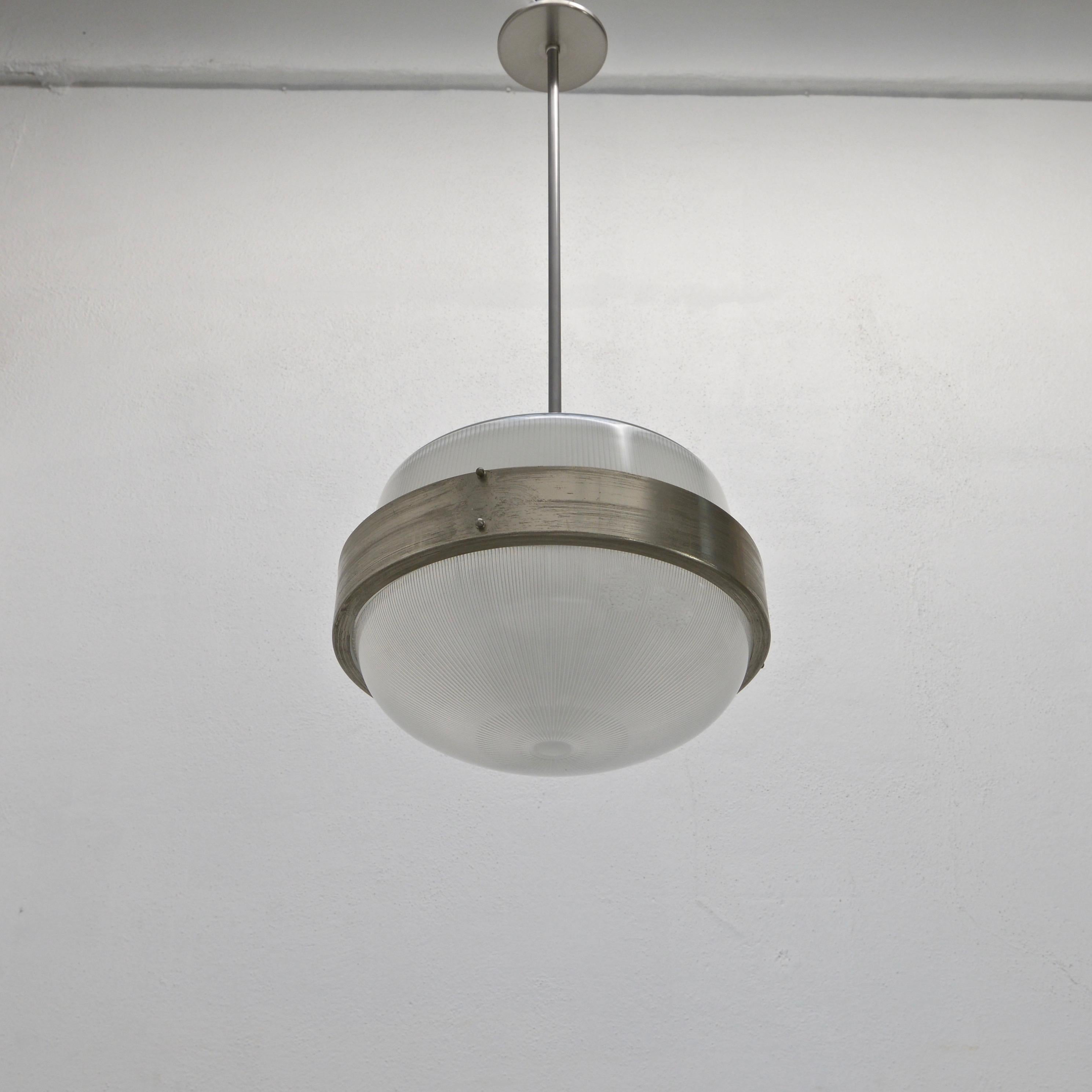 Classic Sergio Mazza pendant from 1960s Italy in Holophane glass and aged nickel. Wired with E26 medium based sockets and wired for use in the US. Light bulbs included with order.
Measurements:
OAD: 35” can be adjusted upon request
Diameter