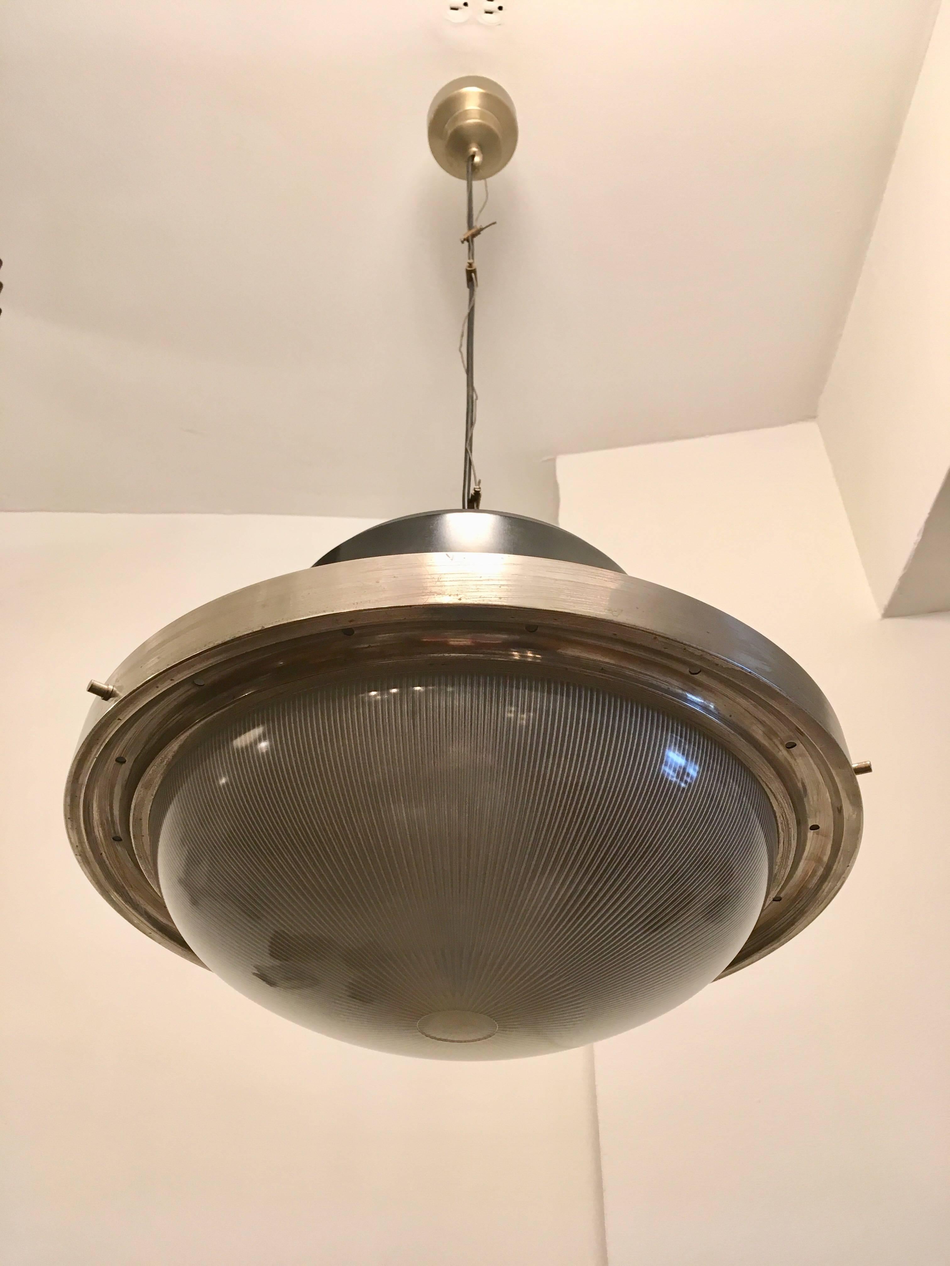An original 1960s Italian pendant designed by Sergio Mazza for Artemide. The Tau model is composed of a black enamels and brushed steel fixture with an industrial glass shade. Newly rewired. A second available if needed.