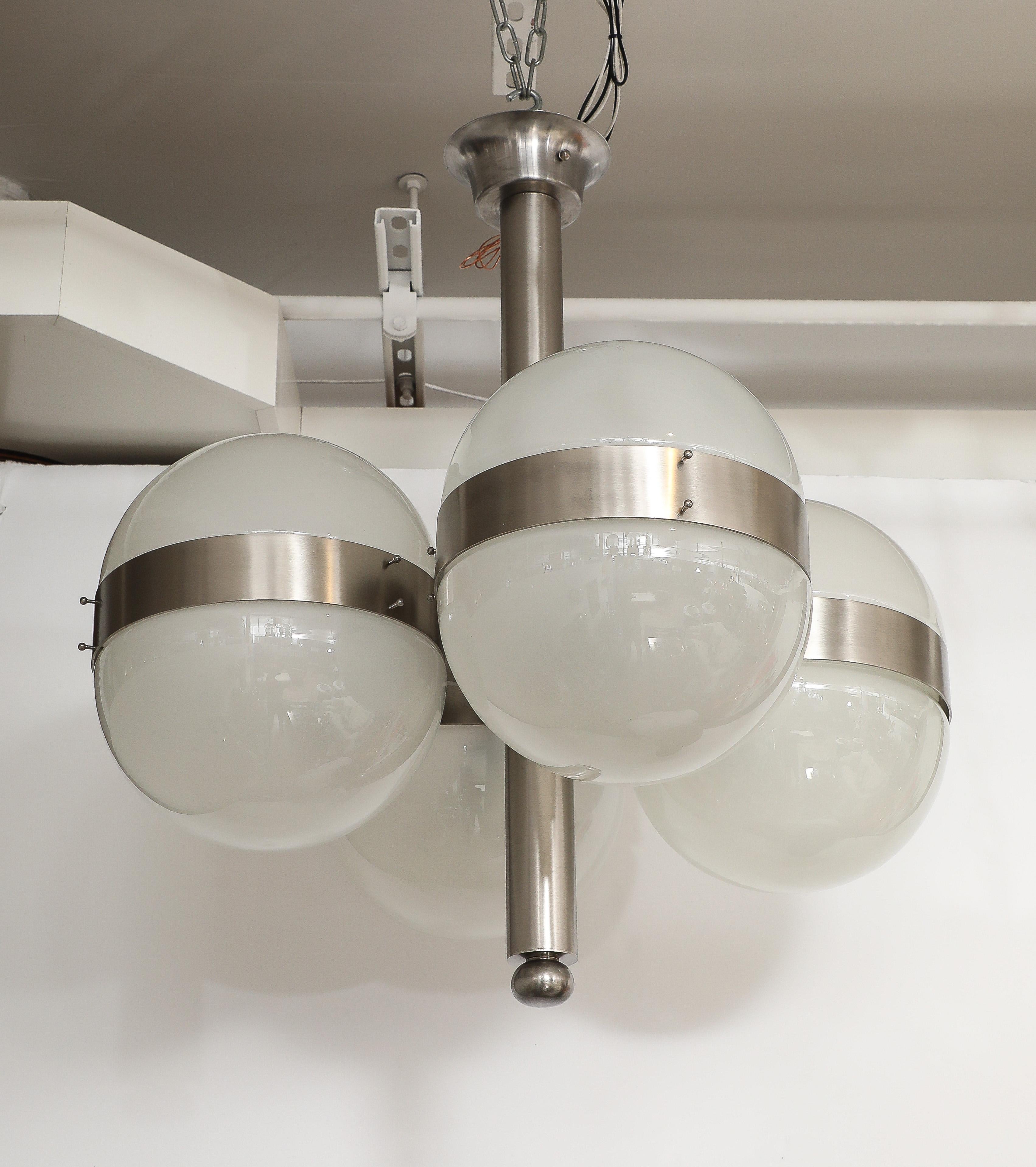 Modernist Italian chandelier designed by Sergio Mazza featuring 8 milk glass domes on a brushed aluminum stem. Meticulously restored metal frame, professionaaly stripped and restored, new sockets and wiring for use in the USA.
