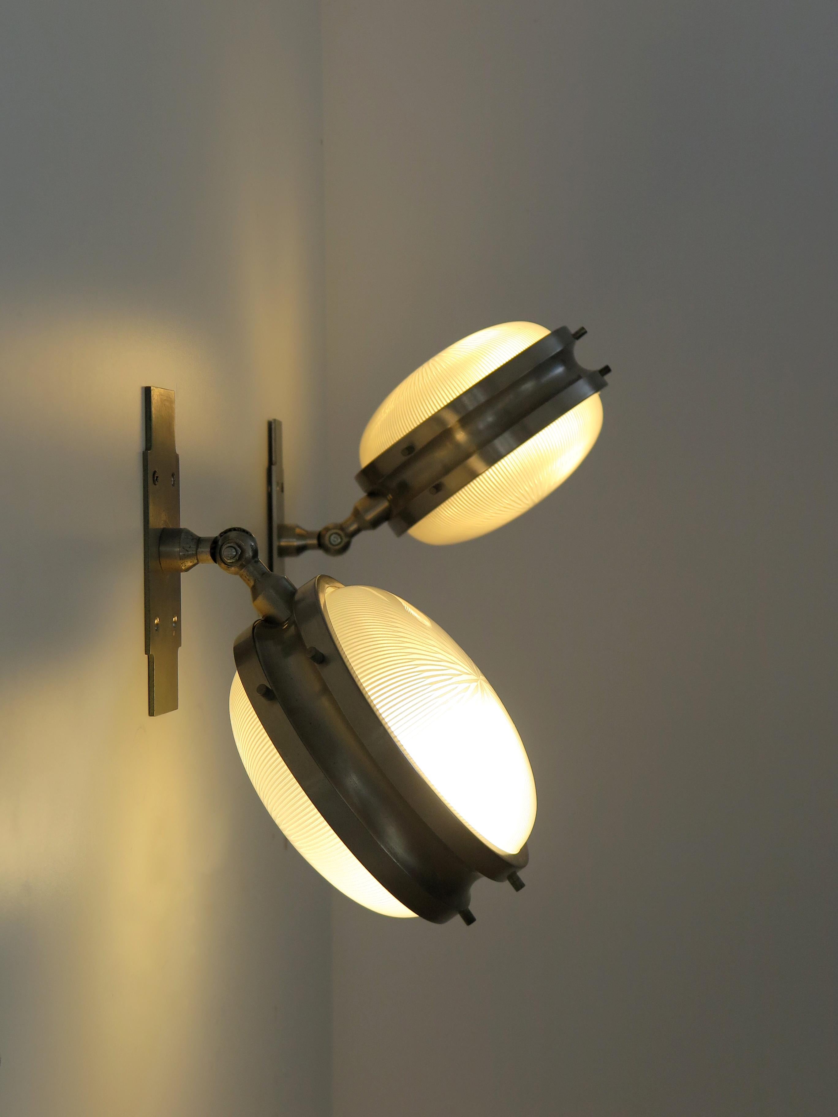 Italian set of two midcentury modern design sconces wall lamps from the Gamma series designed by Sergio Mazza and produced by Artemide with brushed steel frame and thick molded glass diffusers, Italy 1960s.

Please note that the lamps are original