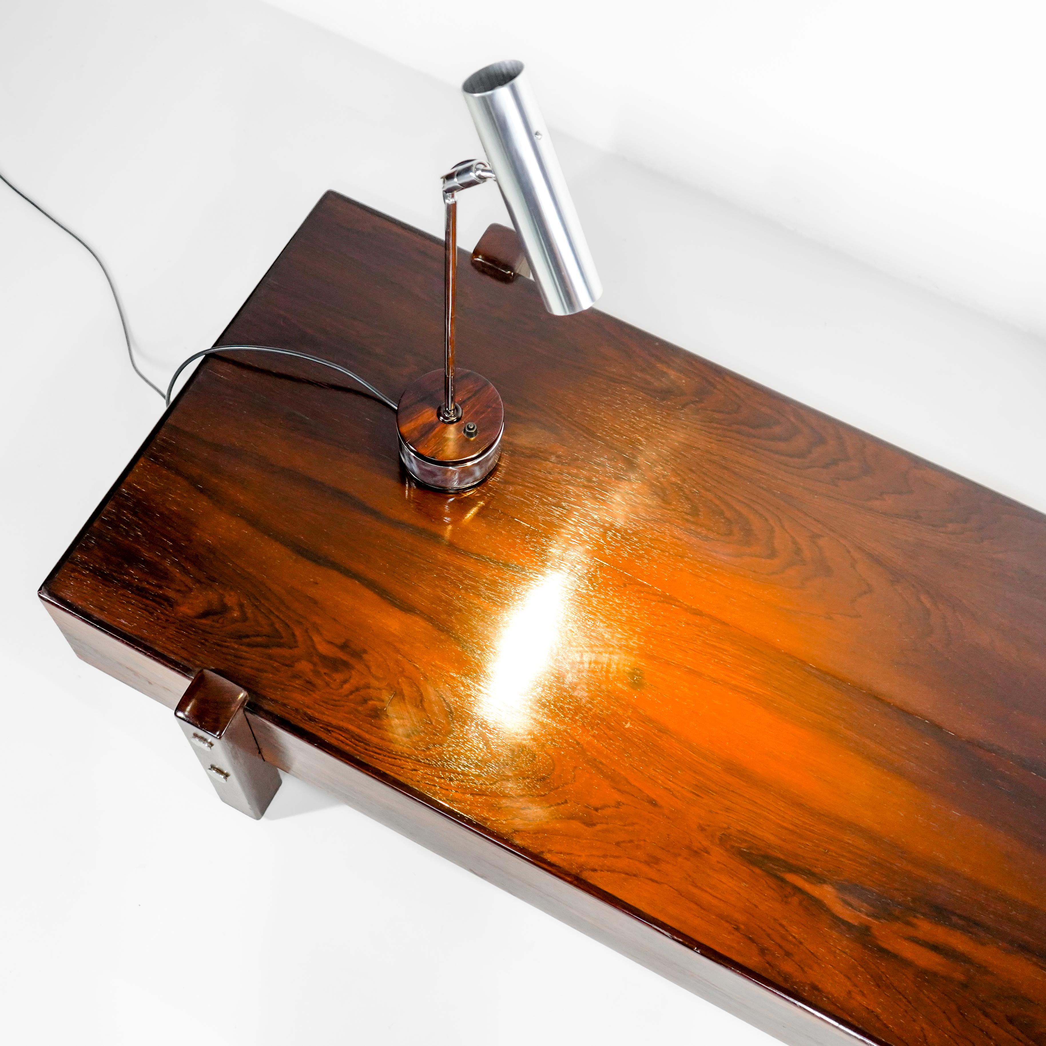 SERGIO RODRIGUES - 1965 - Eleh bench in Rosewood. Solid legs, chrome-plated metal fittings. Can be used as a bench or as a coffee table.

Sergio Roberto Santos Rodrigues (September 22, 1927 – September 1, 2014) was a Brazilian carioca architect and
