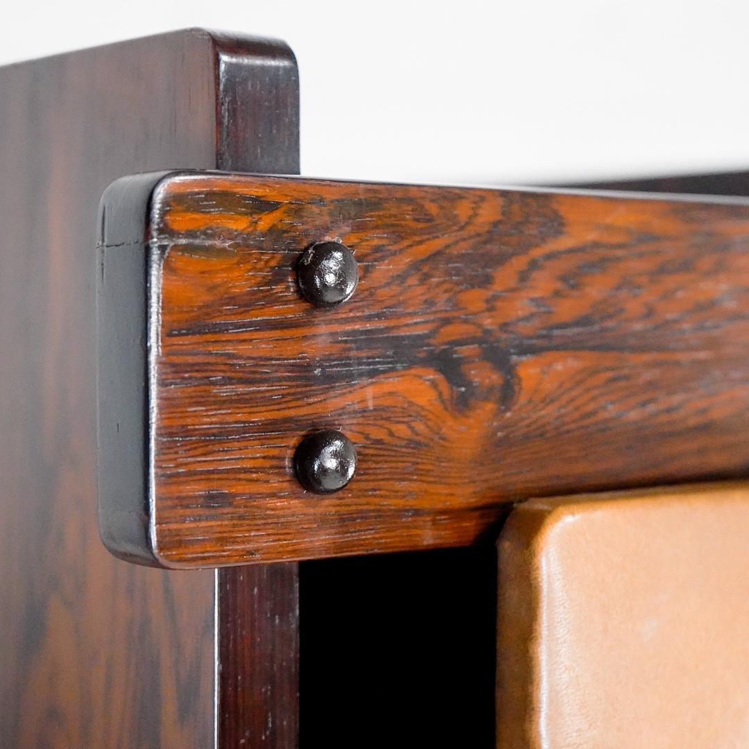 Sergio Rodrigues Bookcase in Jacaranda Wood with Synthetic Leather Doors from the 1960s.

Sergio Roberto Santos Rodrigues (September 22, 1927 – September 1, 2014) was a Brazilian carioca architect and designer. Along with Joaquim Tenreiro and José