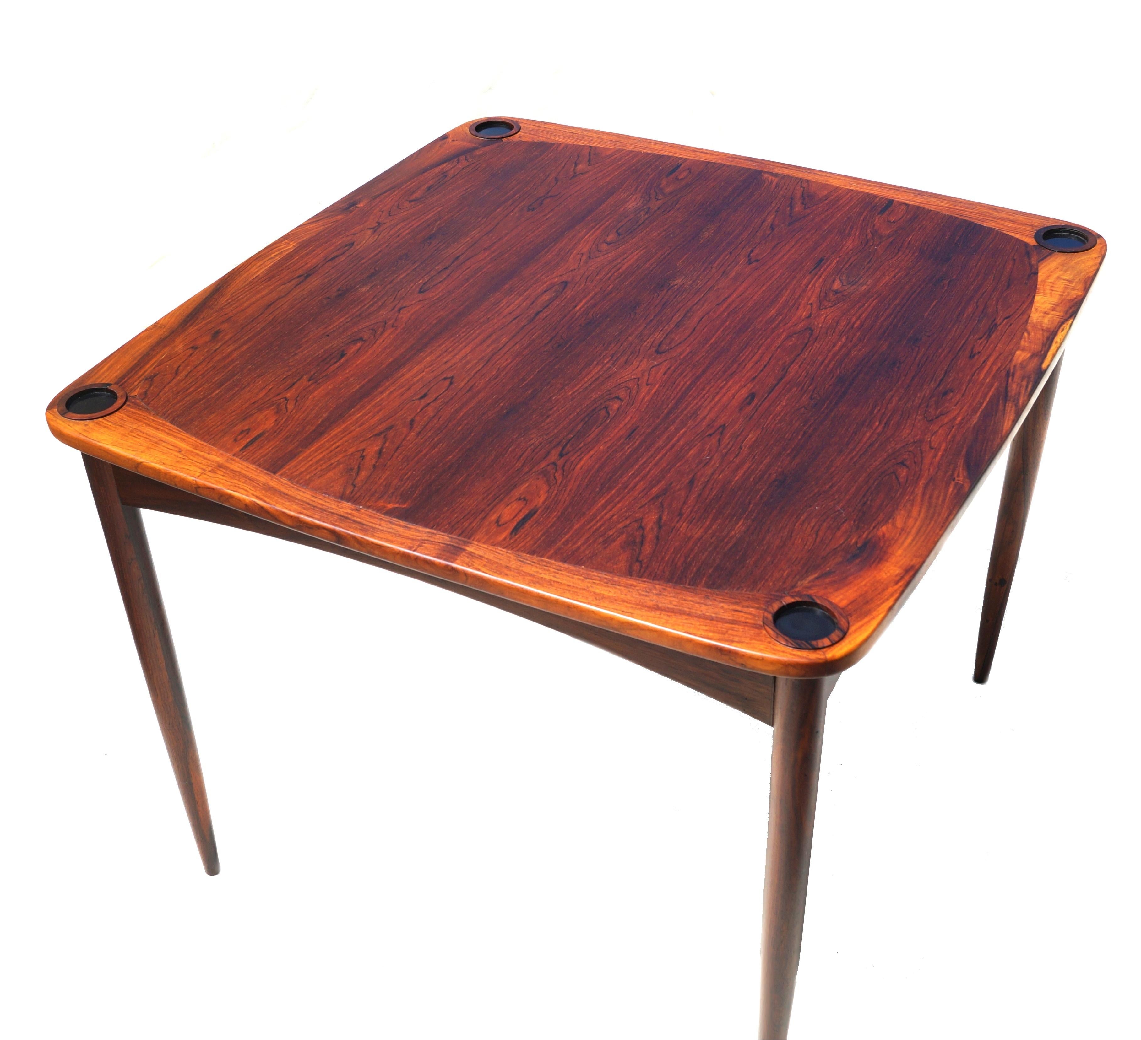 Mid-Century Modern rosewood game table ' Mesa Norma ' with four inset drink holders and reversible top to felt, by Sergio Rodrigues.  This Item may only be shipped within the USA .