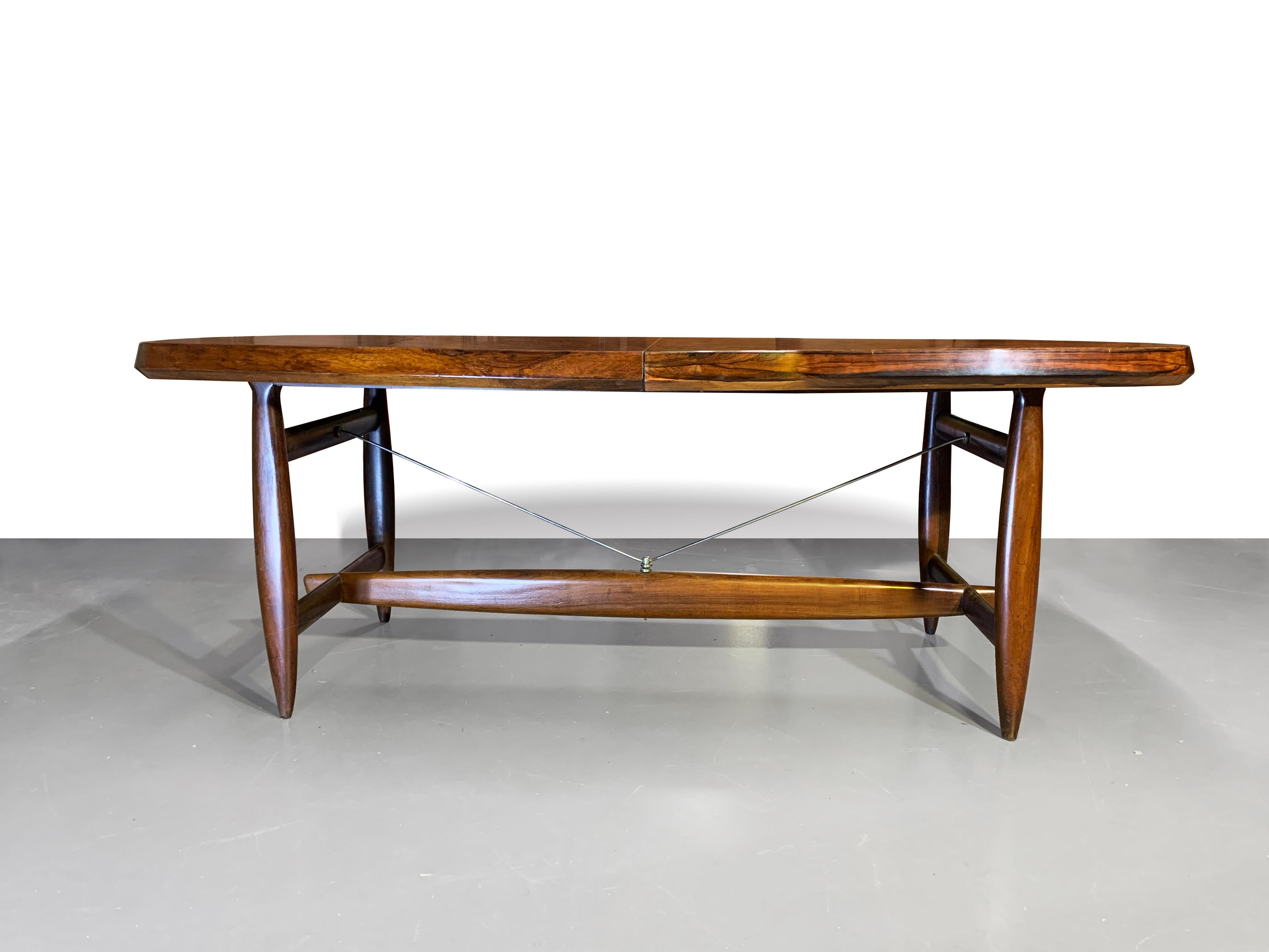 Stunning Brazilian extension dining table designed by Sergio Rodrigues for OCA, Brazil, 1958.
Largely constructed in solid wood and brass hardware details.
The round edged top features an integrated hidden leaf that can extend the table.

The name