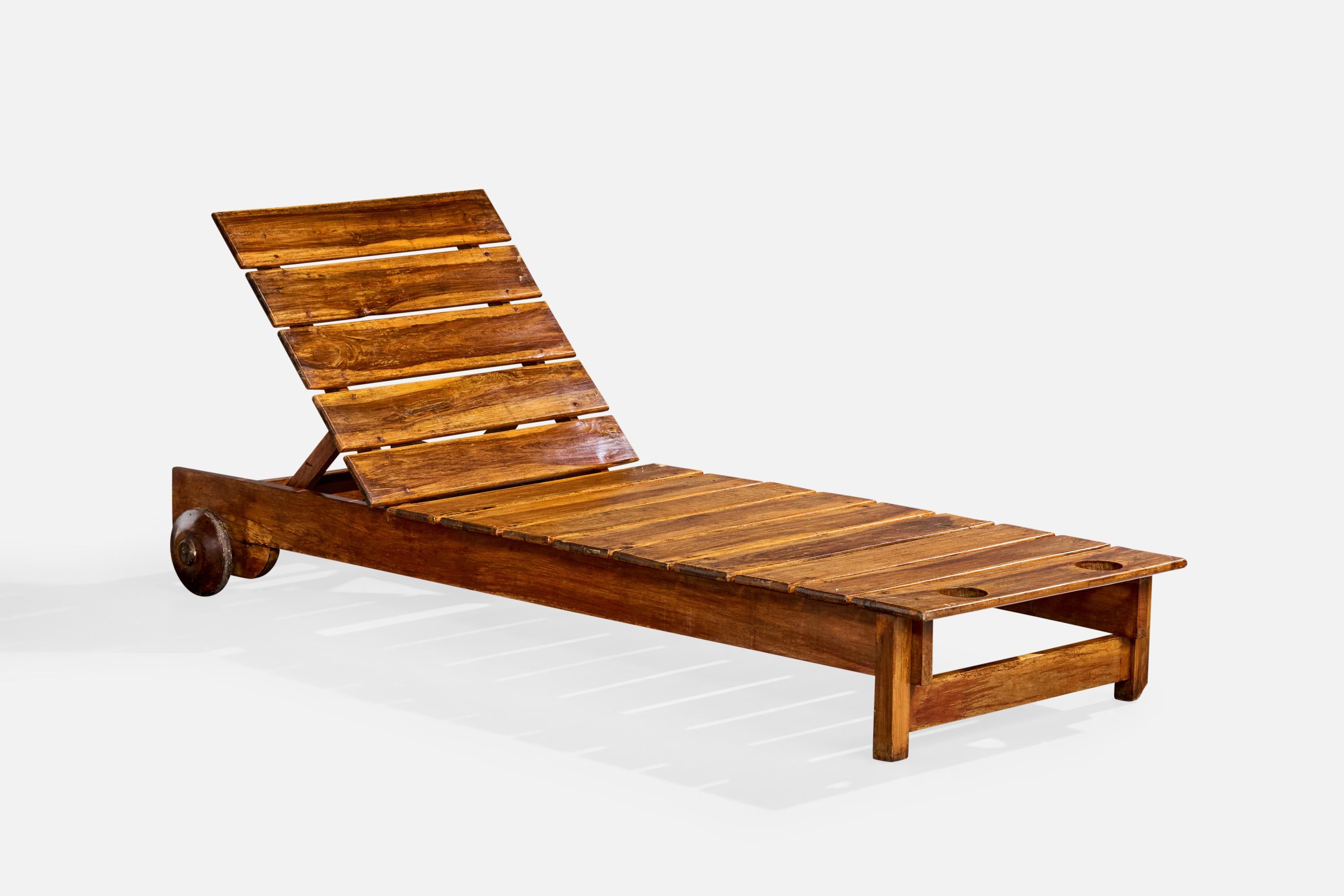 A wood chaise longue or deck chair designed and produced by Sergio Rodrigues, Brazil, c. 1980s.

With dramatic patina suggesting outdoor use. Loss to front leg as illustrated.

Overall Dimensions (inches): 30