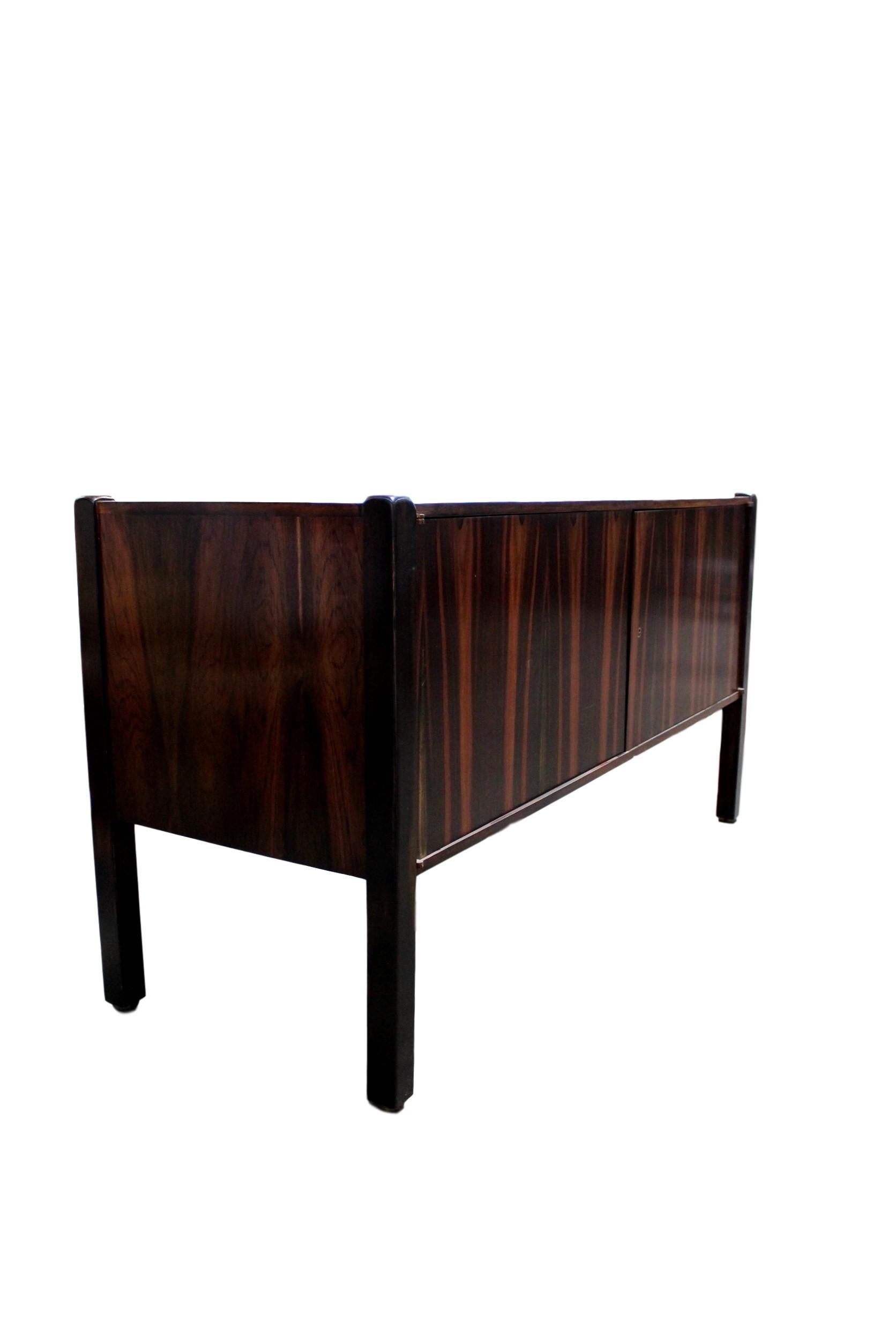 A stunning and exclusive vintage sideboard by the well known Brazilian designer Sergio Rodrigues. It was made in Brazil during the 1960s. The color and grain patterns are gorgeous all-over, even the backside and the whole interior is beautifully