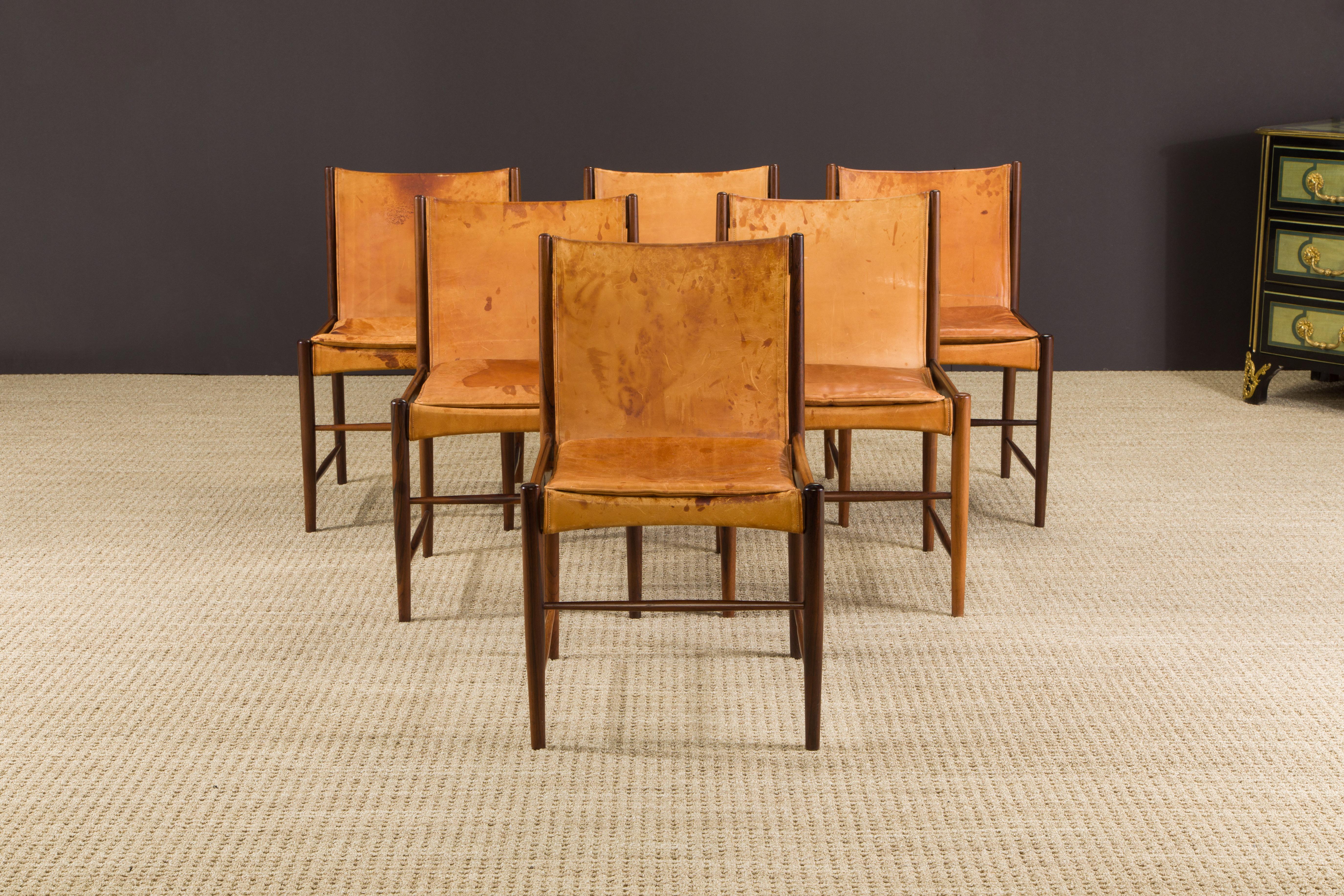 An important set of six (6) Jacaranda Rosewood 'Cantu' dining chairs by Sergio Rodrigues for Oca Arquitetura e Interiores in original leather, signed with labels and Brazilian tax stamps under each chair as can be seen in the photos, this detail is