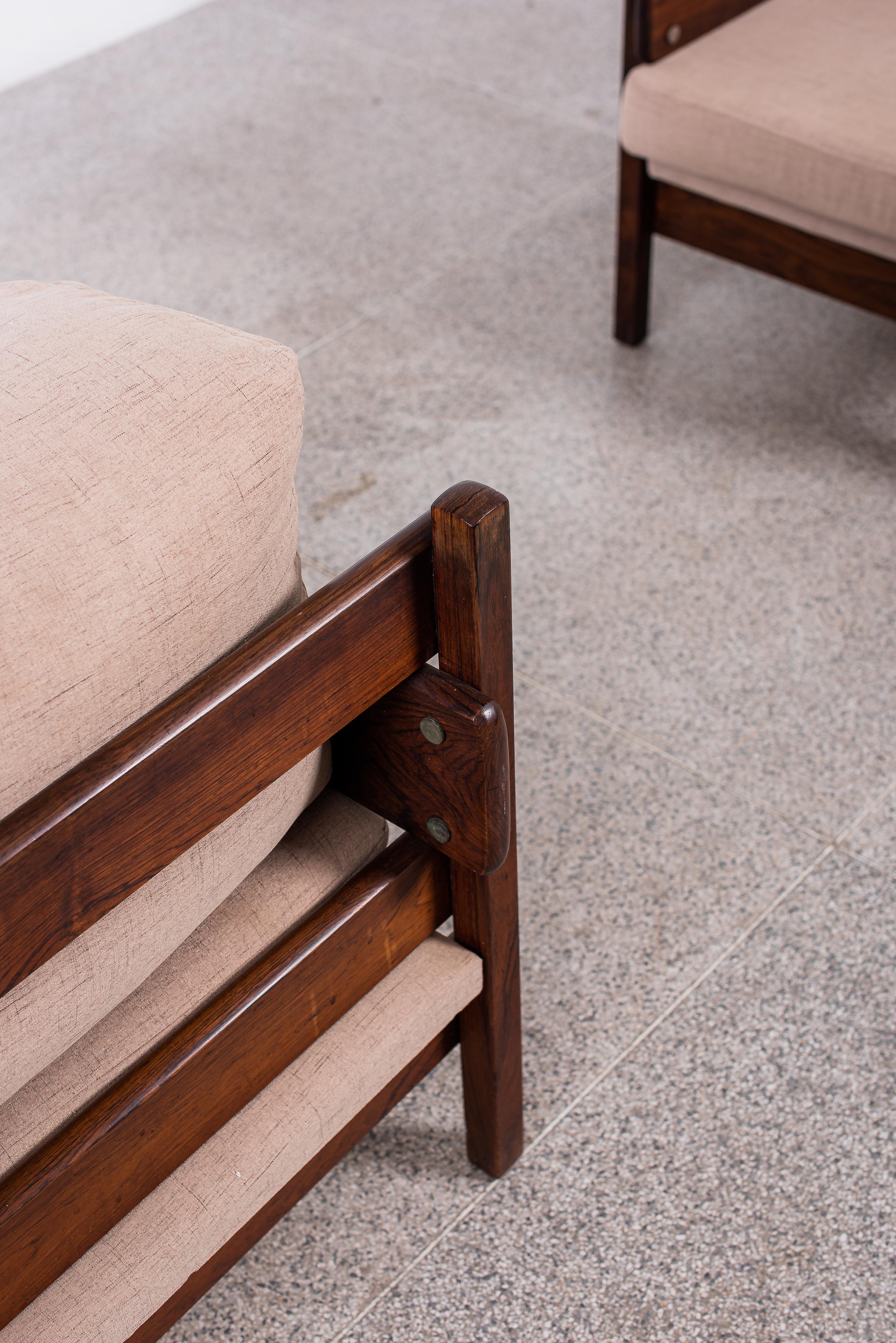Sergio Rodrigues Franco Armchair is a classic mid-century modern piece. The armchair features a wooden frame, often crafted from high-quality wood like jacaranda or rosewood. The frame is typically upholstered in soft fabrics like leather or velvet,